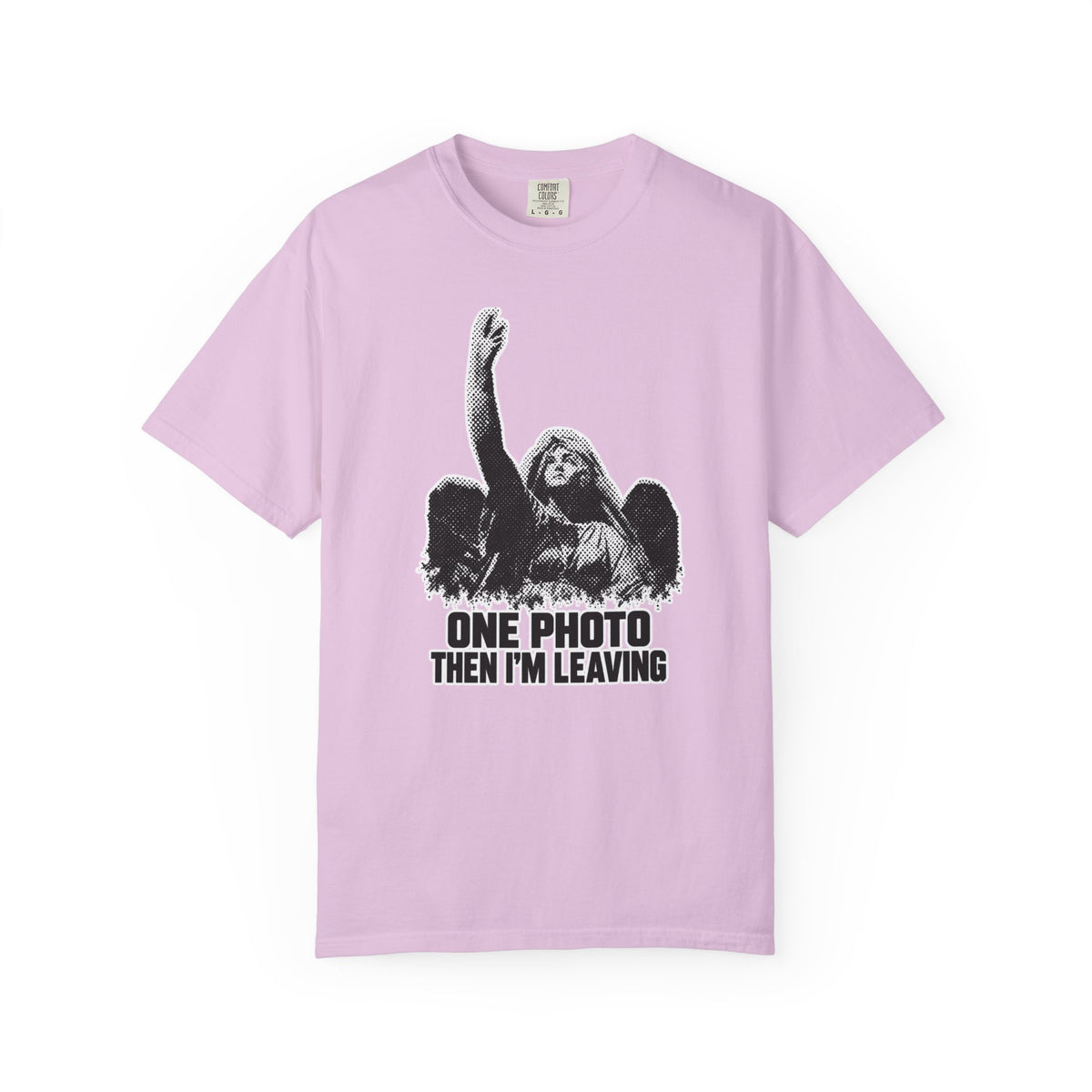 A lavender short-sleeve crewneck t-shirt with a white graphic print of an angel with raised arm and the text 'ONE PHOTO THEN I'M LEAVING' on the front, displayed against a solid white background.