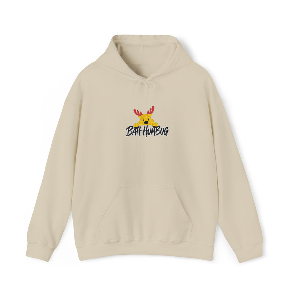 A beige pullover hoodie with a front kangaroo pocket and drawstring hood, featuring a small graphic of a reindeer with red antlers and the text 'BAH HUMBUG' printed on the chest.