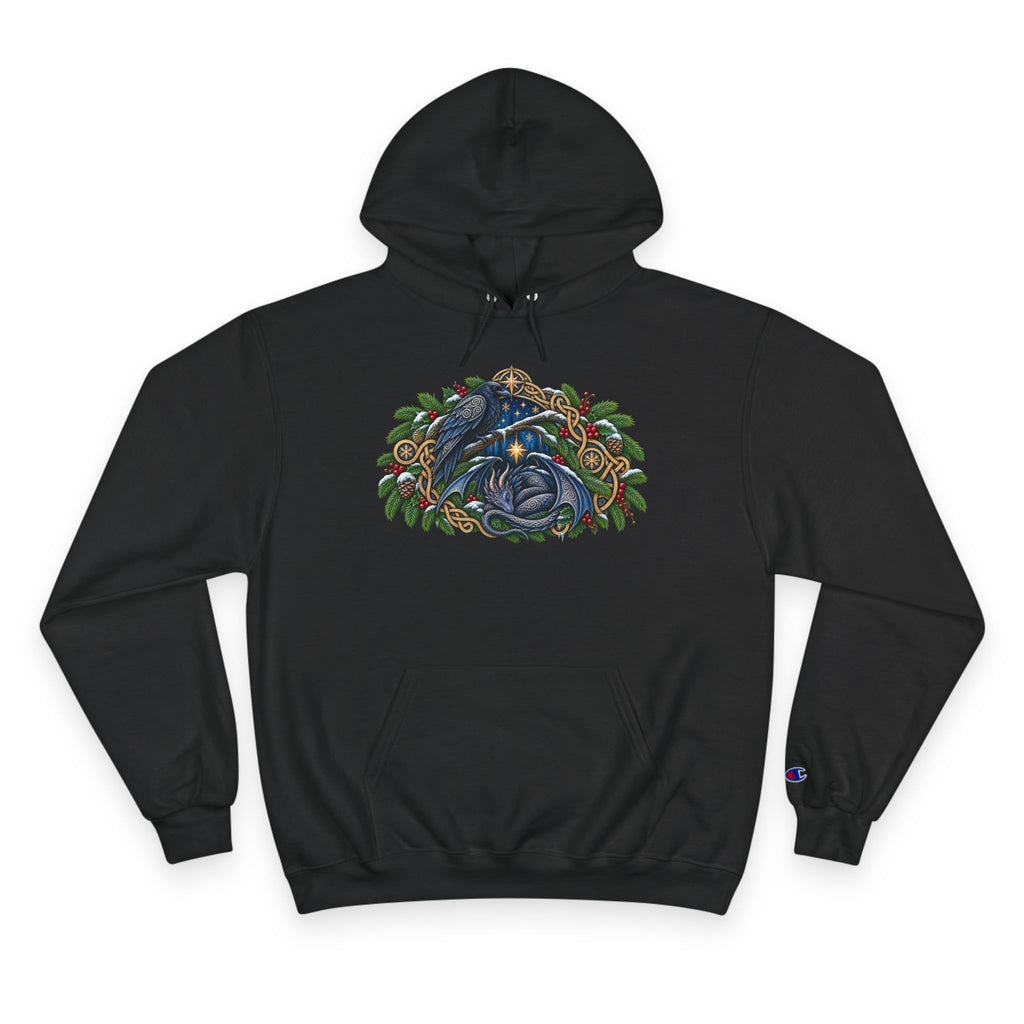 A black pullover hoodie featuring a detailed graphic of a blue raven and a dragon surrounded by green pine boughs  A small blue Champion 'C' logo is visible on the left sleeve cuff. against a white background