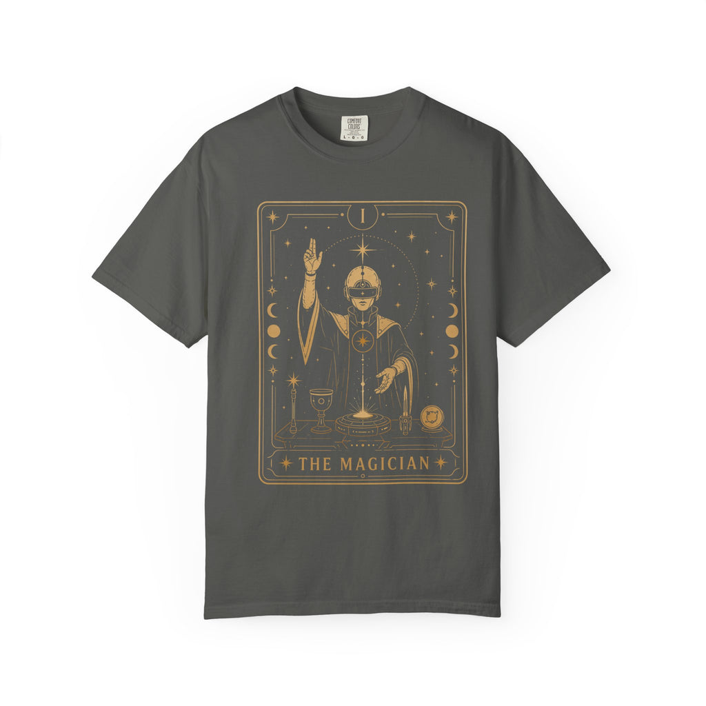 A dark gray crewneck t-shirt featuring a gold-toned graphic print of 'The Magician' tarot card on the front, displayed against a solid white background.