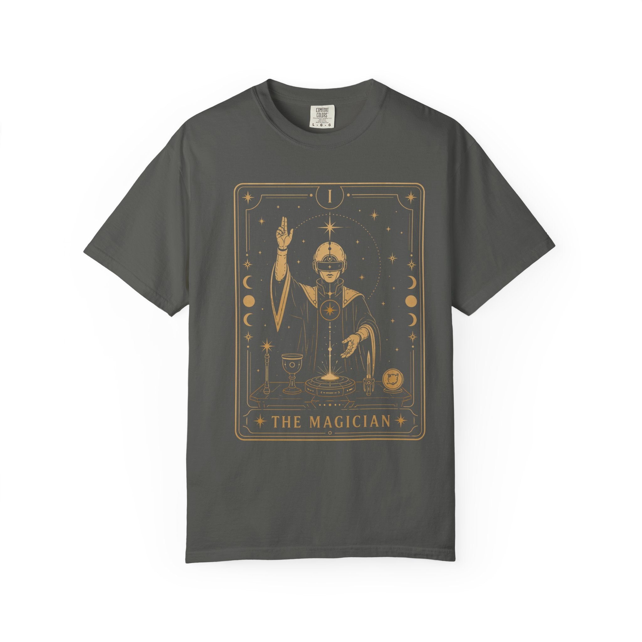 A dark gray crewneck t-shirt featuring a gold-toned graphic print of 'The Magician' tarot card on the front, displayed against a solid white background.