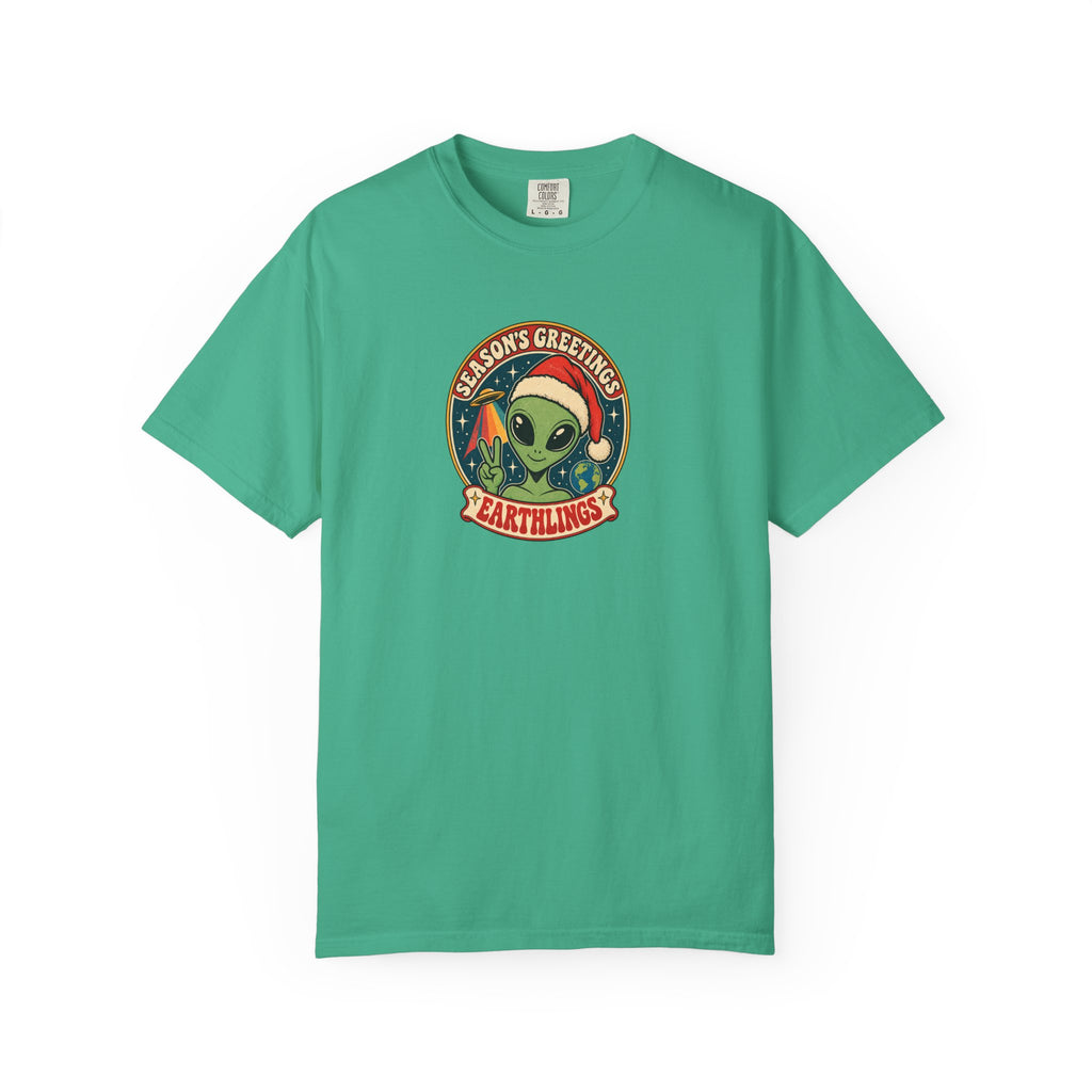 A green short-sleeve crewneck t-shirt featuring a circular retro graphic on the chest with a green alien wearing a Santa hat and the text 'MARS GREETINGS' and 'EARTHINGS'.