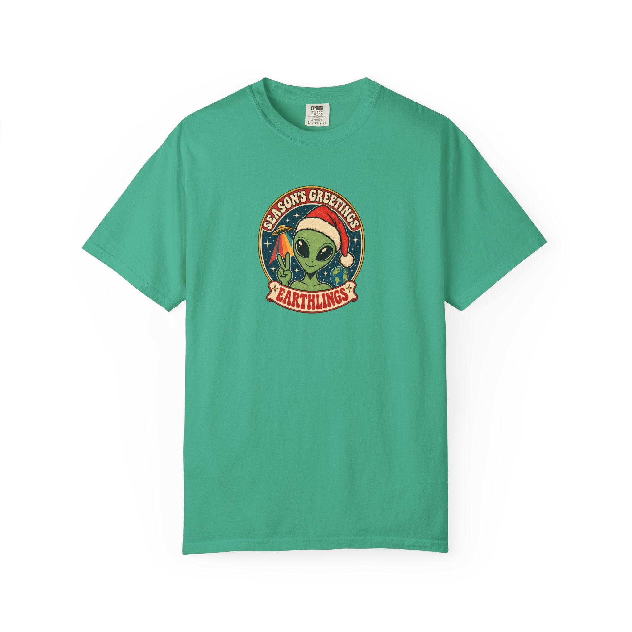 A green short-sleeve crewneck t-shirt featuring a circular retro graphic on the chest with a green alien wearing a Santa hat and the text 'MARS GREETINGS' and 'EARTHINGS'.