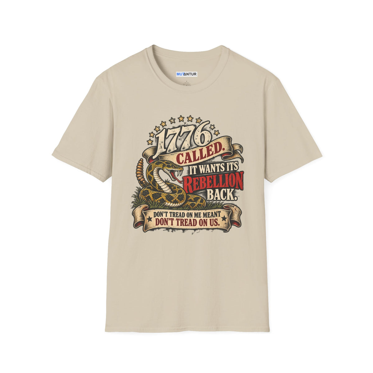 A beige short-sleeve crewneck t-shirt featuring a detailed graphic print on the front. The graphic depicts a coiled rattlesnake with the text '1776 CALLED IT WANTS ITS REBELLION BACK DONT TREAD ON ME MEANS DONT TREAD ON US  against a white background
