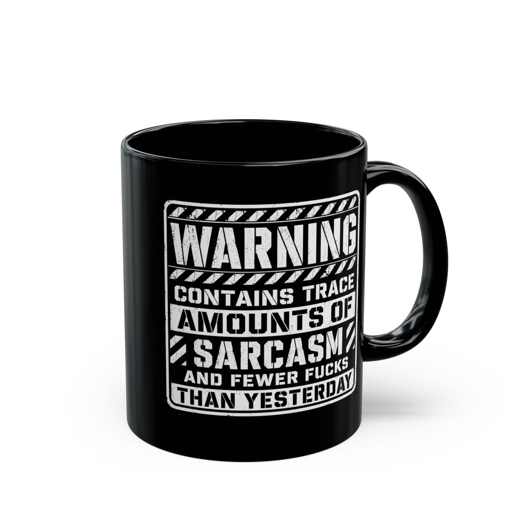 Black ceramic coffee mug printed with the warning label "Contains Trace Amounts of Sarcasm."