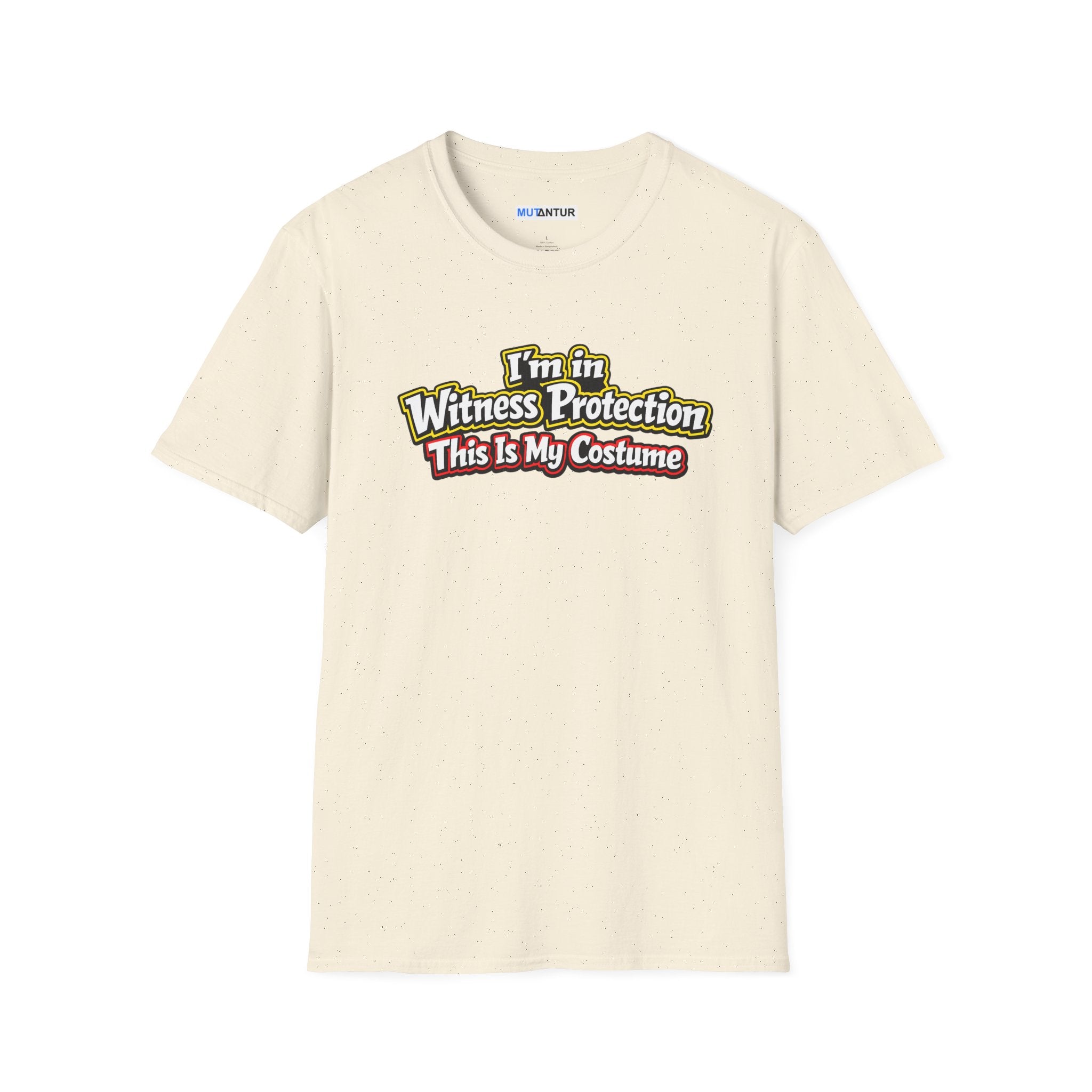 Beige short-sleeve crewneck t-shirt featuring a graphic on the chest that reads 'I'm in Witness Protection This Is My Costume' in a stylized, vintage font with green, yellow, and red accents
