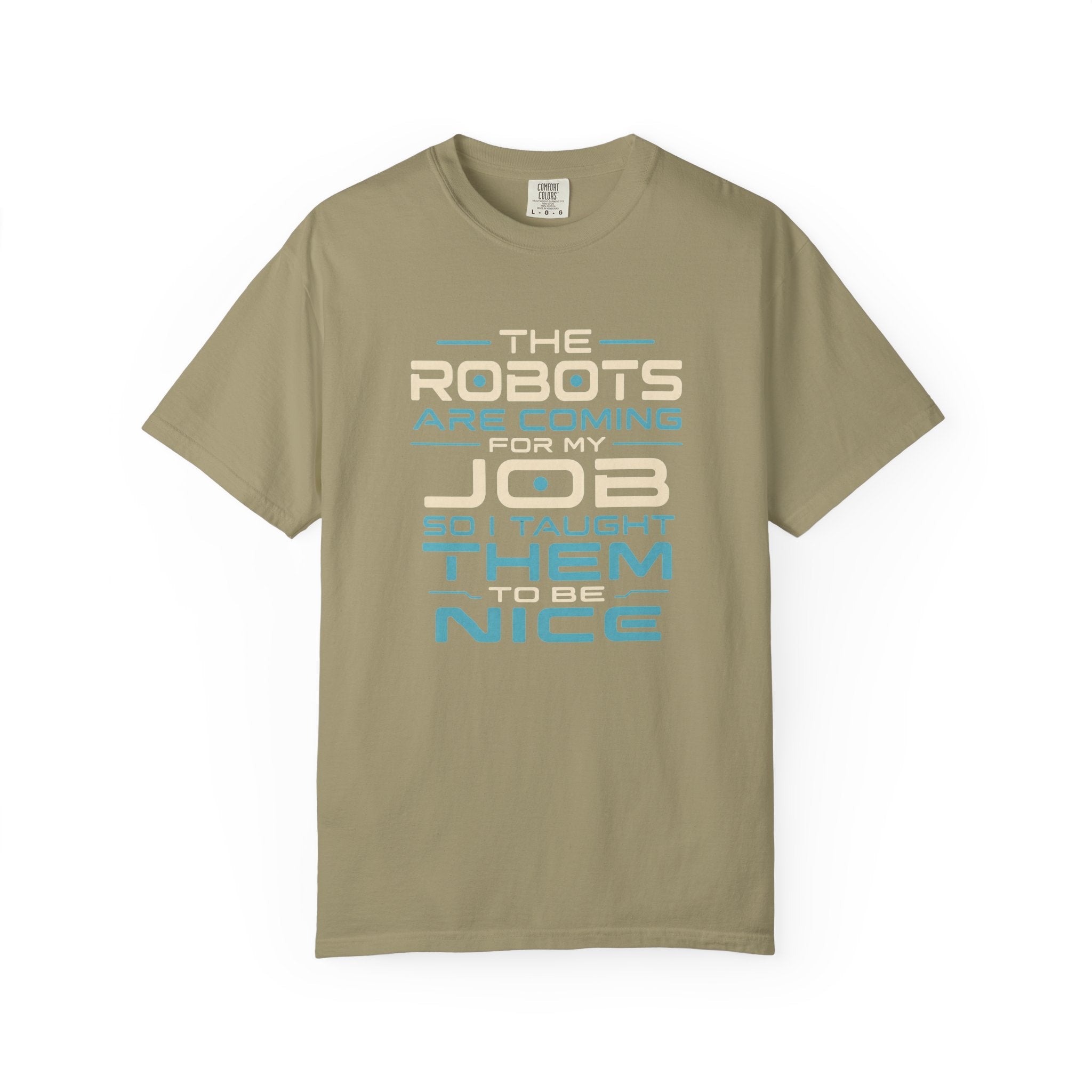 A short-sleeve crewneck t-shirt in a muted khaki-beige color, featuring a graphic text print on the front that reads 'THE ROBOTS ARE COMING FOR MY JOB SO I TAUGHT THEM TO BE NICE' in cream and light blue lettering, displayed on a clean white background.