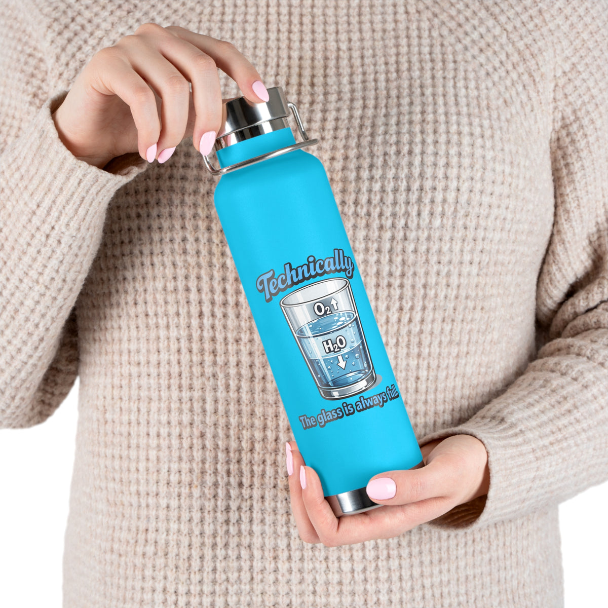 A person in a beige knit sweater holds a bright blue insulated water bottle with a stainless steel lid. The bottle has a printed graphic of a glass labeled O2 and H2O with the text 'Technically' and 'No glass is pure'.