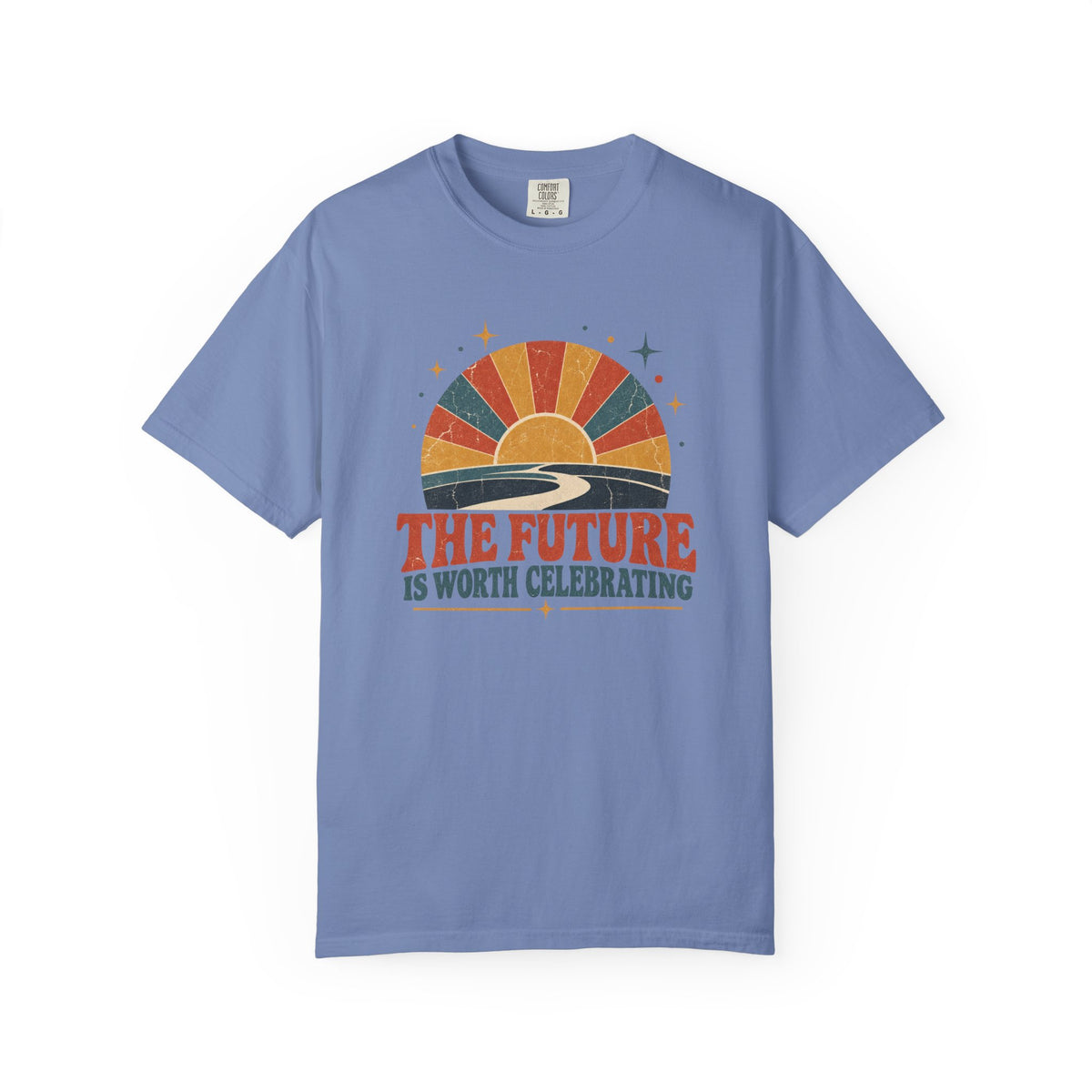 A light blue crewneck t-shirt with a retro sunset graphic and the text 'THE FUTURE IS WORTH CELEBRATING' printed on the chest, displayed on a clean white background.