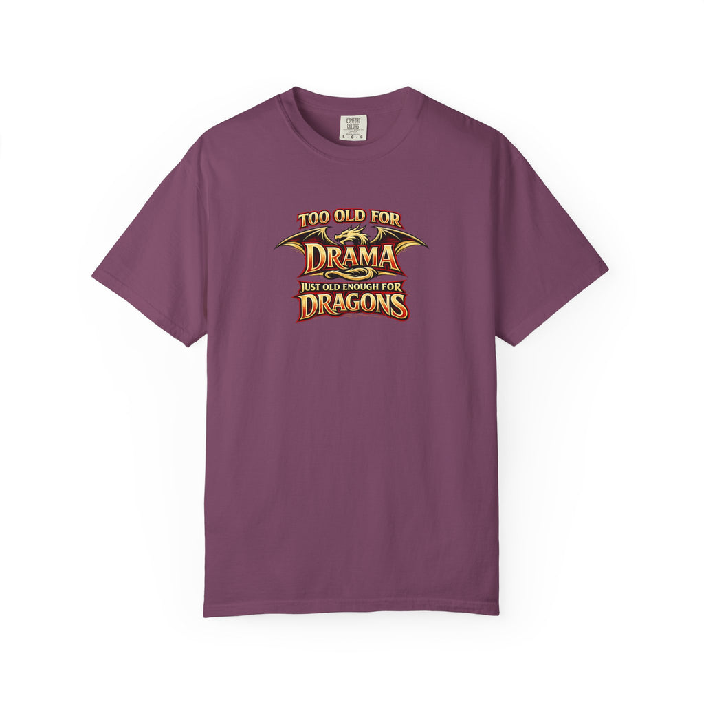 An purple short-sleeve crewneck t-shirt featuring a graphic print on the chest that reads 'TOO OLD FOR DRAMA BUT OLD ENOUGH FOR DRAGONS' in a stylized gold and black dragon-themed font.