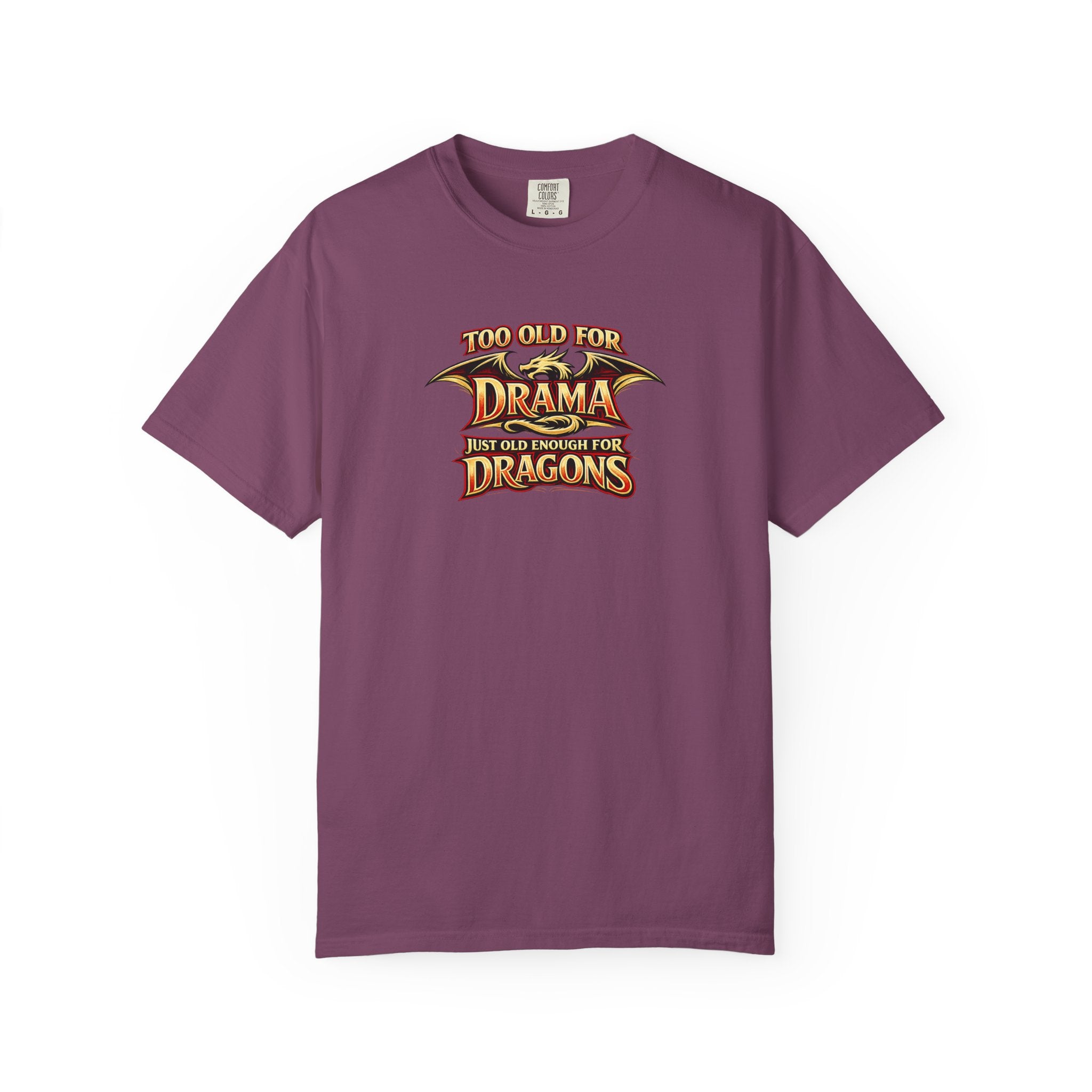 An purple short-sleeve crewneck t-shirt featuring a graphic print on the chest that reads 'TOO OLD FOR DRAMA BUT OLD ENOUGH FOR DRAGONS' in a stylized gold and black dragon-themed font.