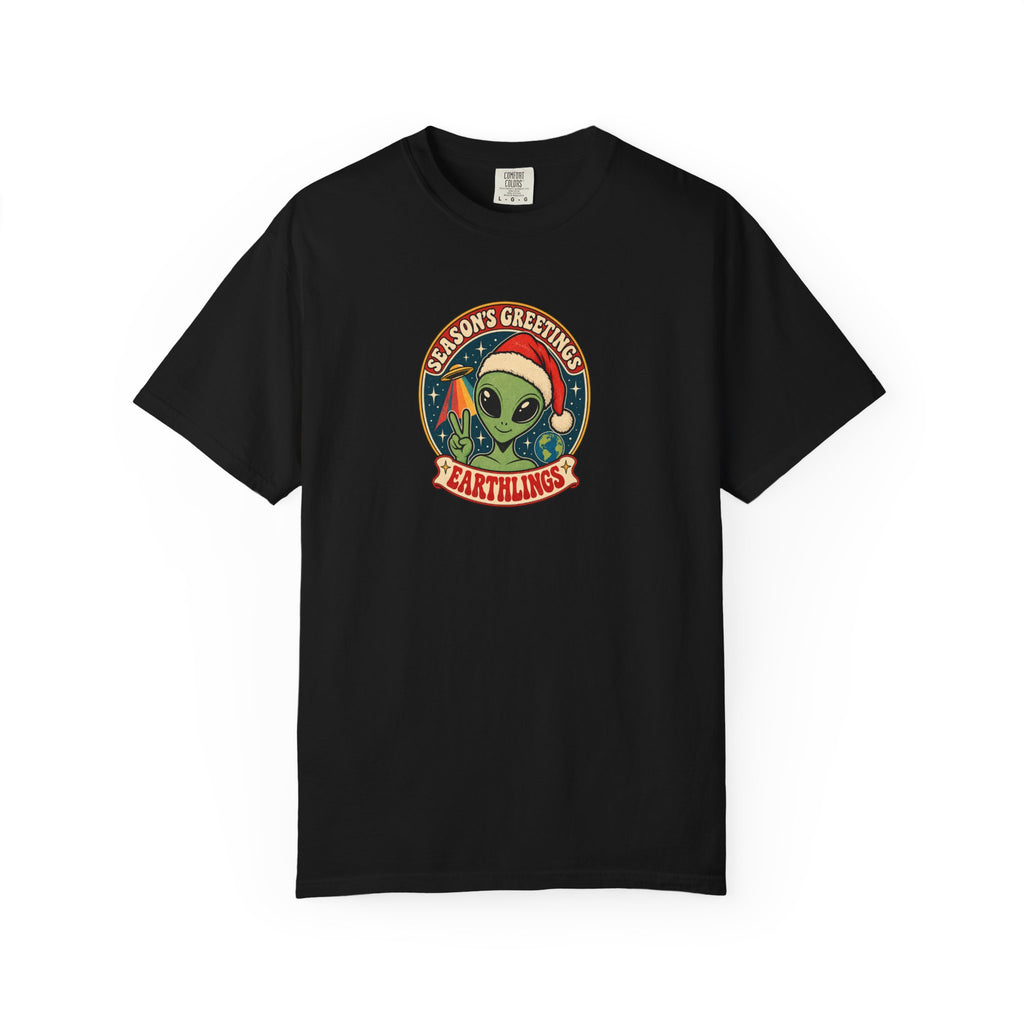 A black short-sleeve crewneck t-shirt featuring a circular graphic on the chest with a green alien wearing a Santa hat and the text 'ALIENS GREETINGS' and 'EARTHLINGS'.