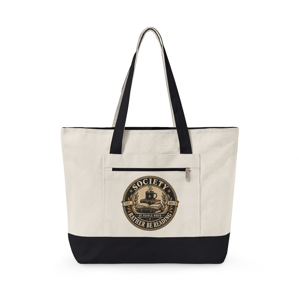 Beige tote bag with black accents featuring a graphic design pf a badge for the Society of those who's rather be reading on a white background