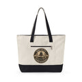 Beige tote bag with black accents featuring a graphic design pf a badge for the Society of those who's rather be reading on a white background