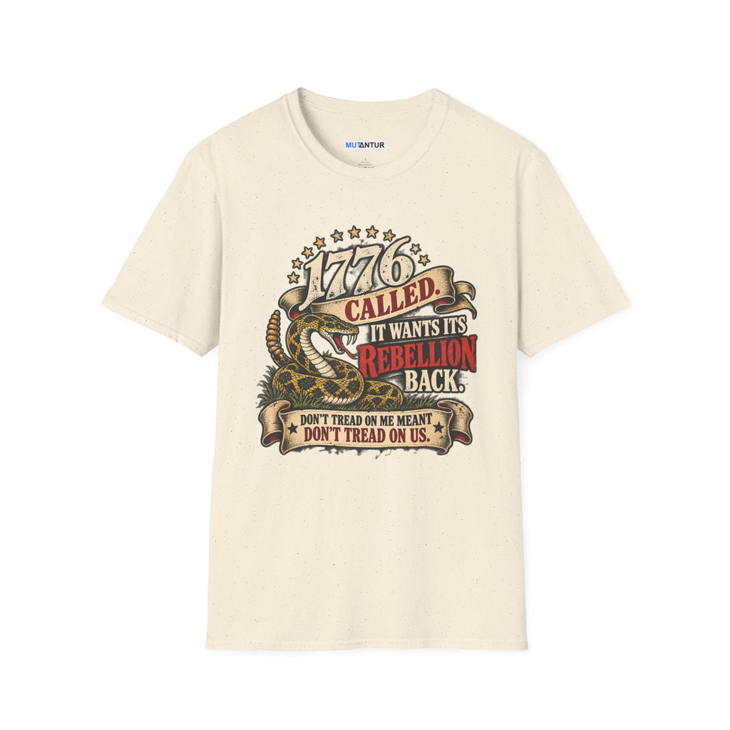 A cream colored short-sleeve crewneck t-shirt featuring a detailed graphic print on the front. The graphic depicts a coiled rattlesnake with the text '1776 CALLED IT WANTS ITS REBELLION BACK DONT TREAD ON ME MEANS DONT TREAD ON US  against a white background