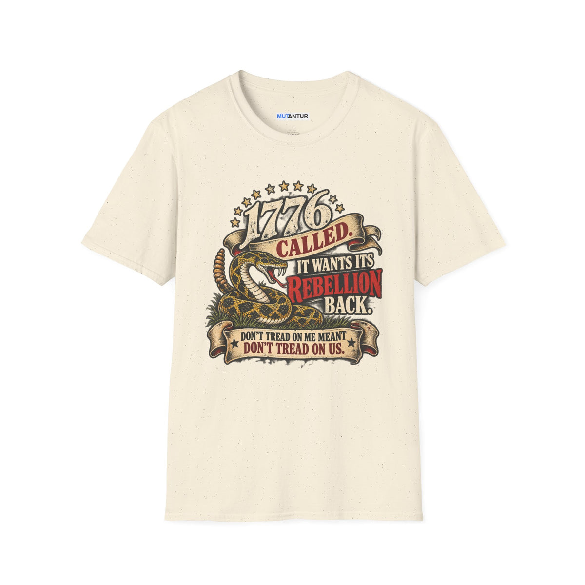 A cream colored short-sleeve crewneck t-shirt featuring a detailed graphic print on the front. The graphic depicts a coiled rattlesnake with the text '1776 CALLED IT WANTS ITS REBELLION BACK DONT TREAD ON ME MEANS DONT TREAD ON US  against a white background