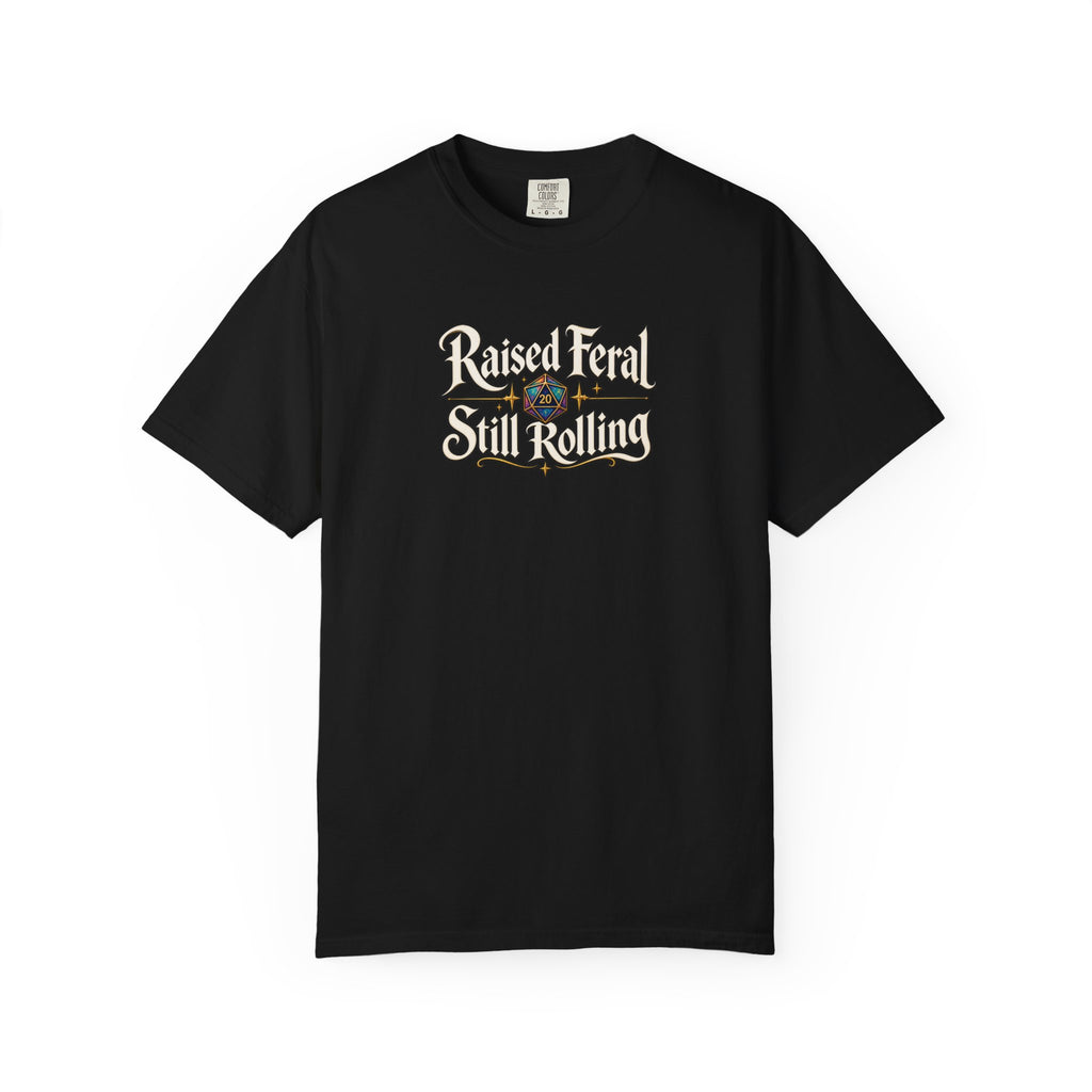 A black graphic T-shirt  that features the text 'Raised Feral Still Rolling' with a colorful 20-sided die graphic in the center against a white background