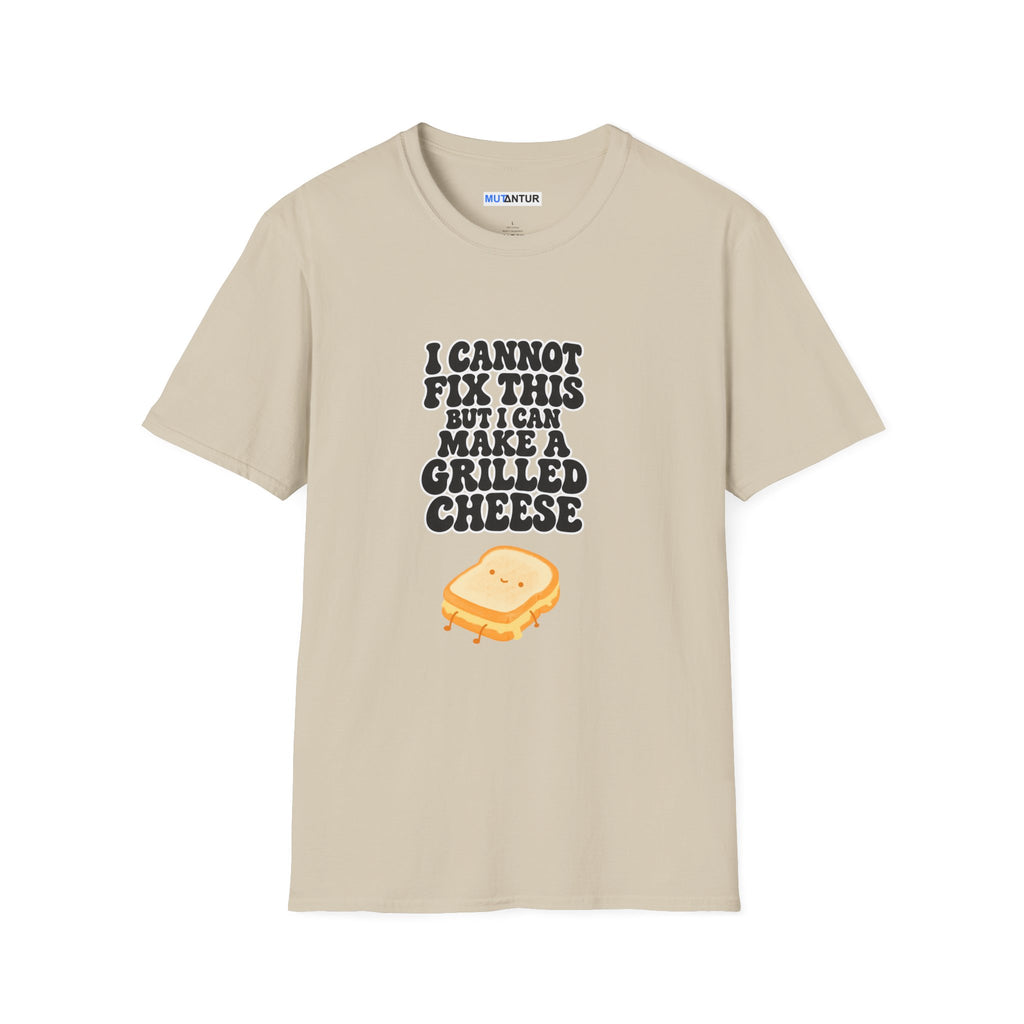A beige crewneck t-shirt with a graphic print that reads 'I CANNOT FIX THIS BUT I CAN MAKE A GRILLED CHEESE' in black text above a small cartoon grilled cheese sandwich, shown on a plain white background.