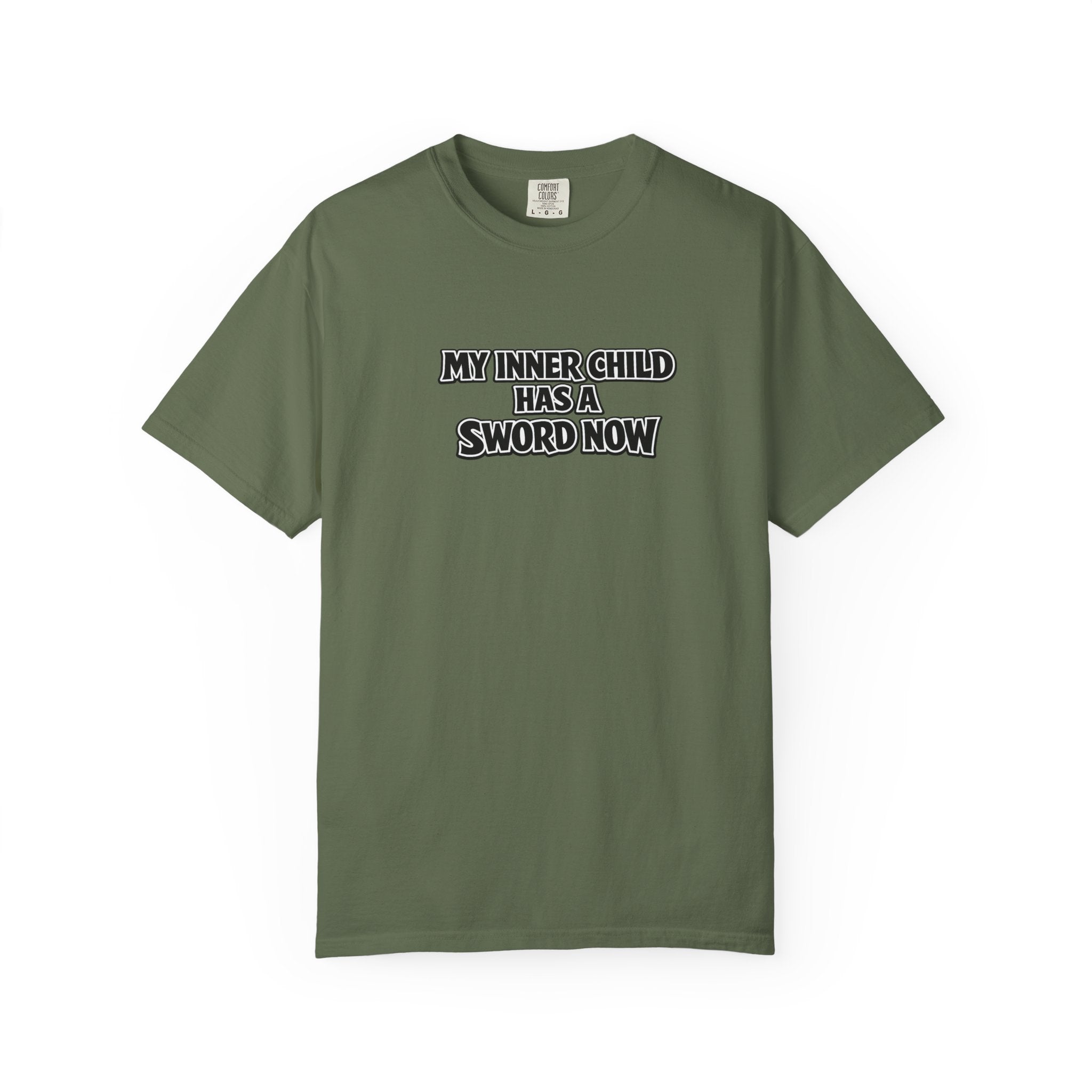 An green short-sleeve crewneck t-shirt with the text 'MY INNER-CHILD HAS A SWORD NOW' printed in black and white block letters across the chest, displayed on a clean white background.