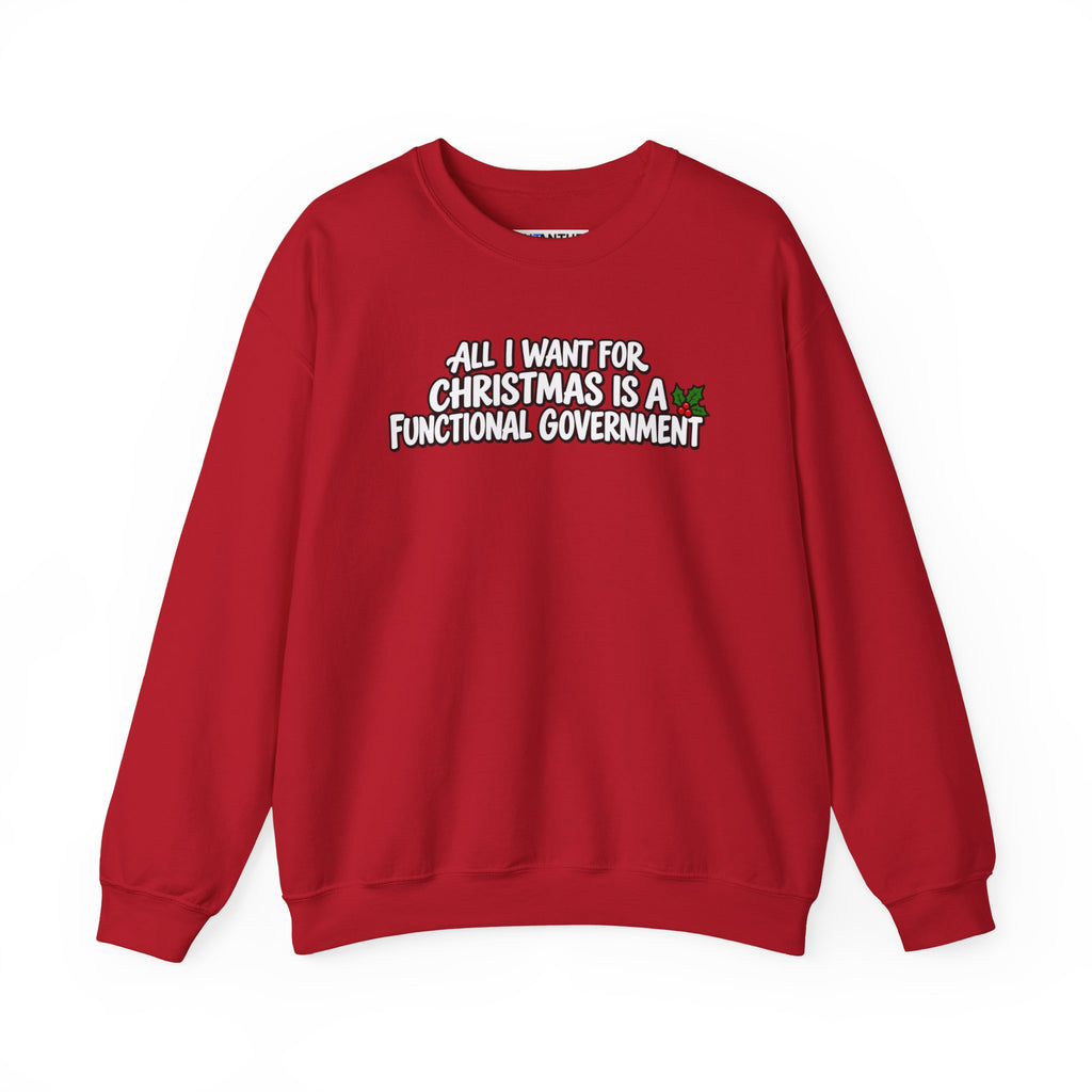 A red crewneck sweatshirt with a graphic text print on the chest that reads 'ALL I WANT FOR CHRISTMAS IS A FUNCTIONAL GOVERNMENT' in white letters with a black outline, accompanied by a small red and green holiday sprig.