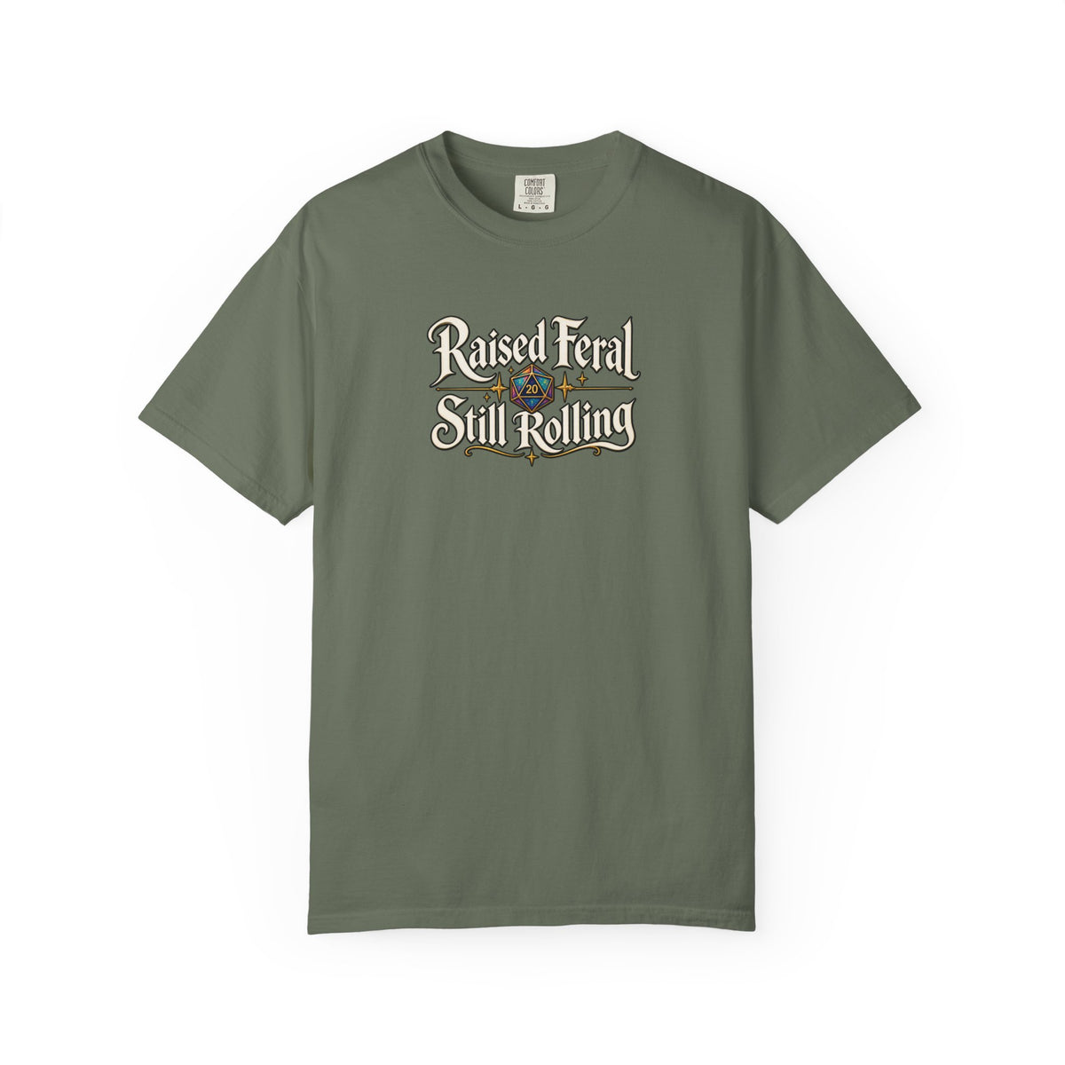 A green graphic T-shirt  that features the text 'Raised Feral Still Rolling' with a colorful 20-sided die graphic in the center against a white background