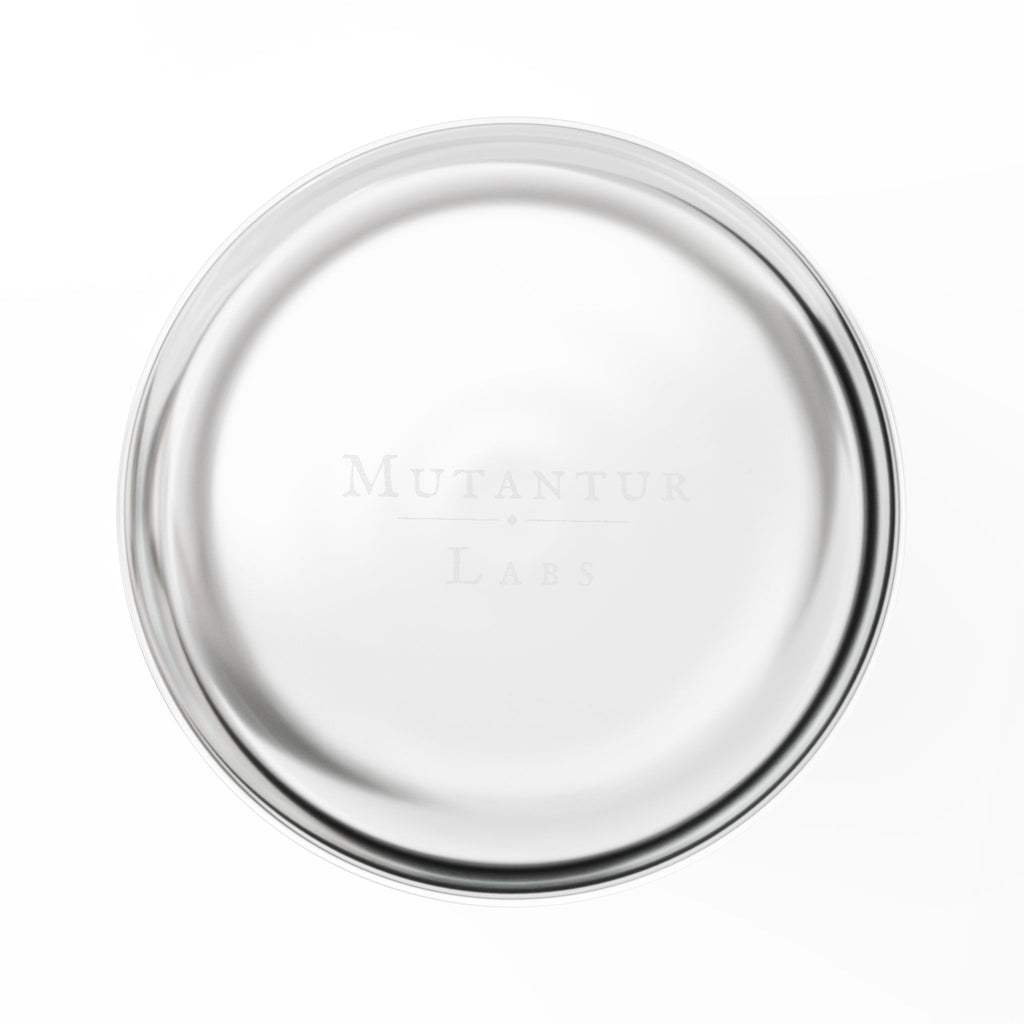 Bottom of a glass tumbler with a brand logo on a white background