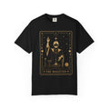 A black Comfort Colors t-shirt featuring The Magician from the Future Arcana collection, inspired by The Magician tarot card. A futuristic cosmic mystic channels radiant energy above a celestial altar within an elegant Art Deco frame rendered in vintage gold line art on a transparent background.