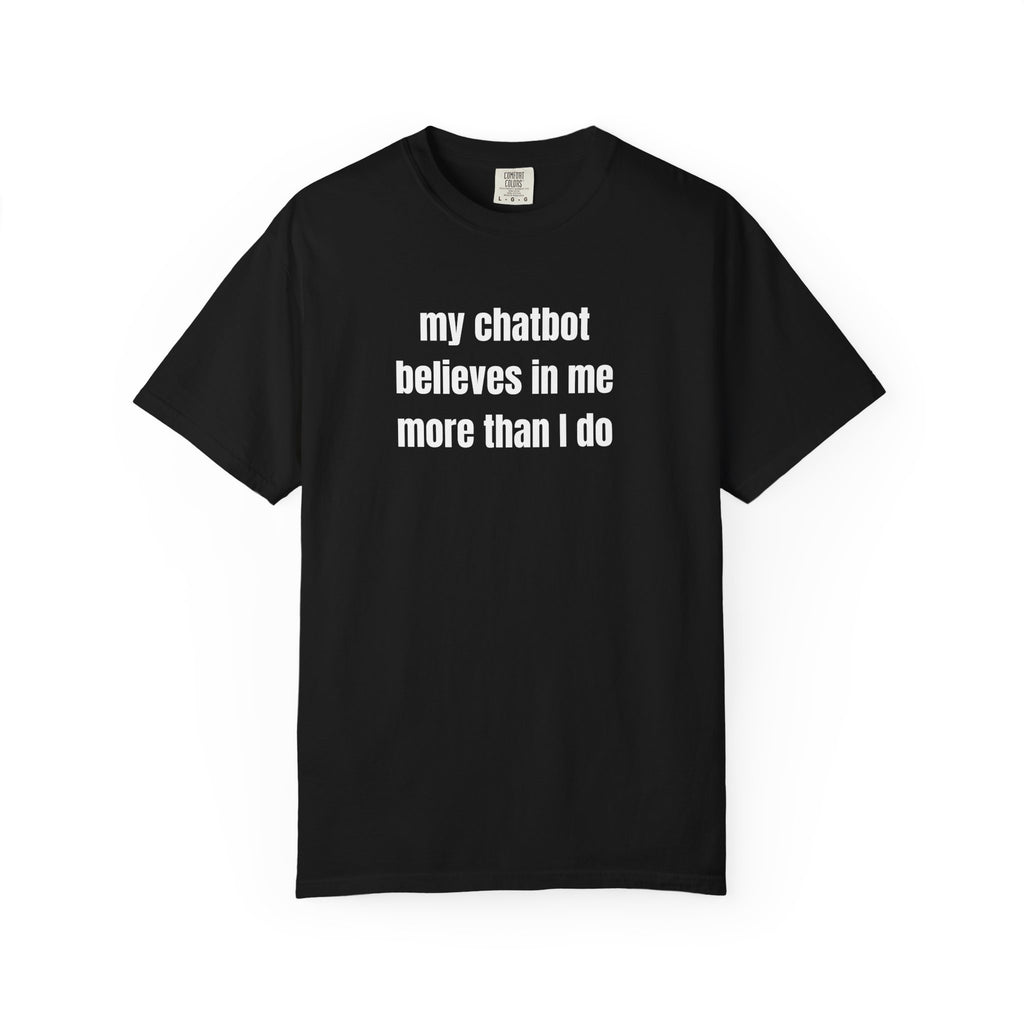 A black short-sleeve crewneck t-shirt with the text 'my chatbot believes in me more than I do' printed in black sans-serif font across the chest, displayed on a clean white background.