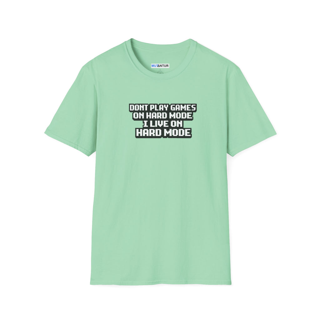 A mint green short-sleeve t-shirt with a black and white graphic text print on the chest that reads 'DONT PLAY GAMES ON HARD MODE I LIVE ON HARD MODE'.