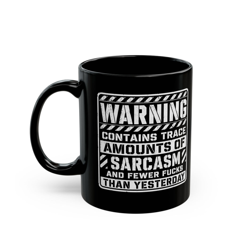 Black ceramic coffee mug printed with the warning label "Contains Trace Amounts of Sarcasm."
