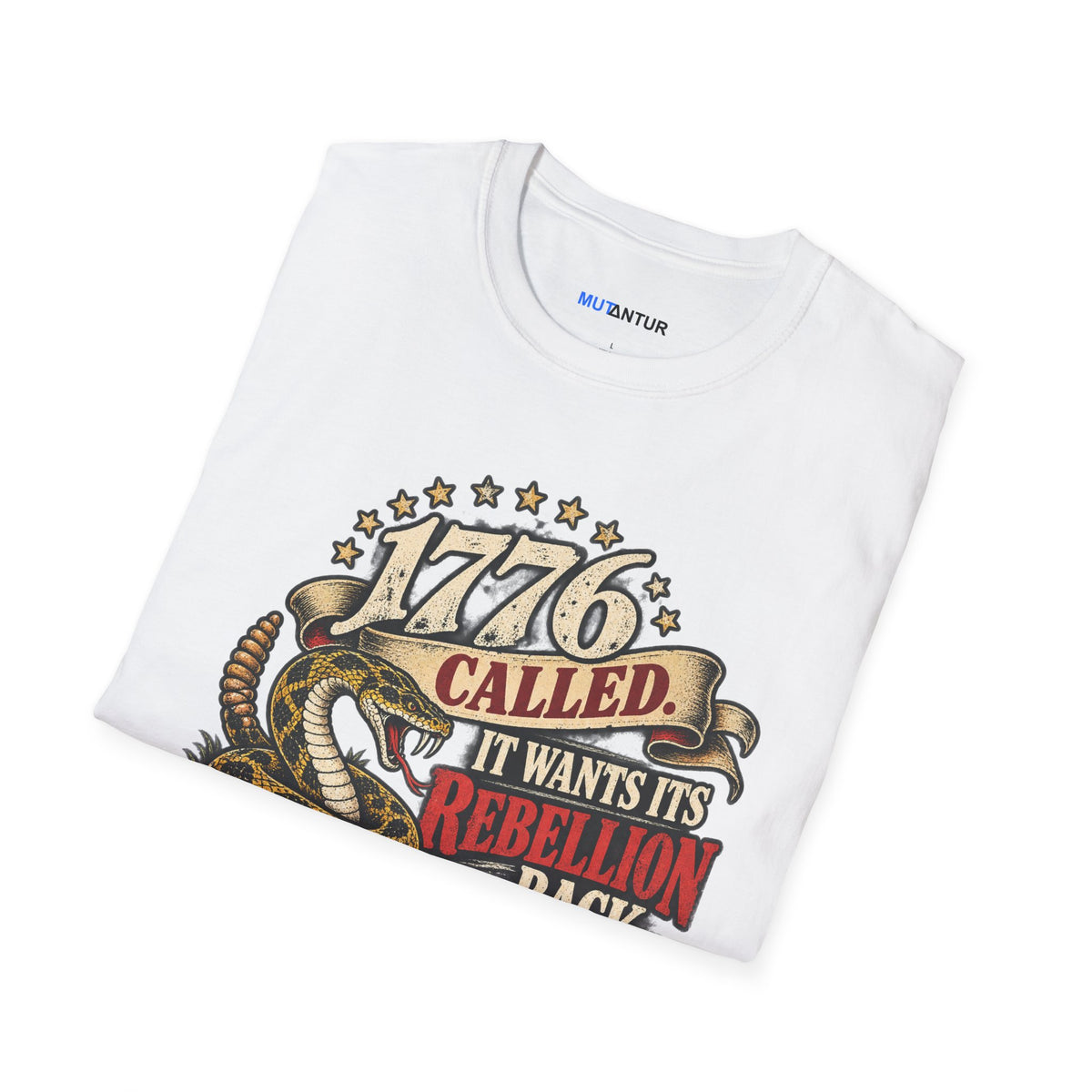 A folded white t-shirt with a vintage-style graphic print featuring a coiled rattlesnake and the text '1776 CALLED IT WANTS ITS REBELLION BACK' in red, gold, and black.
