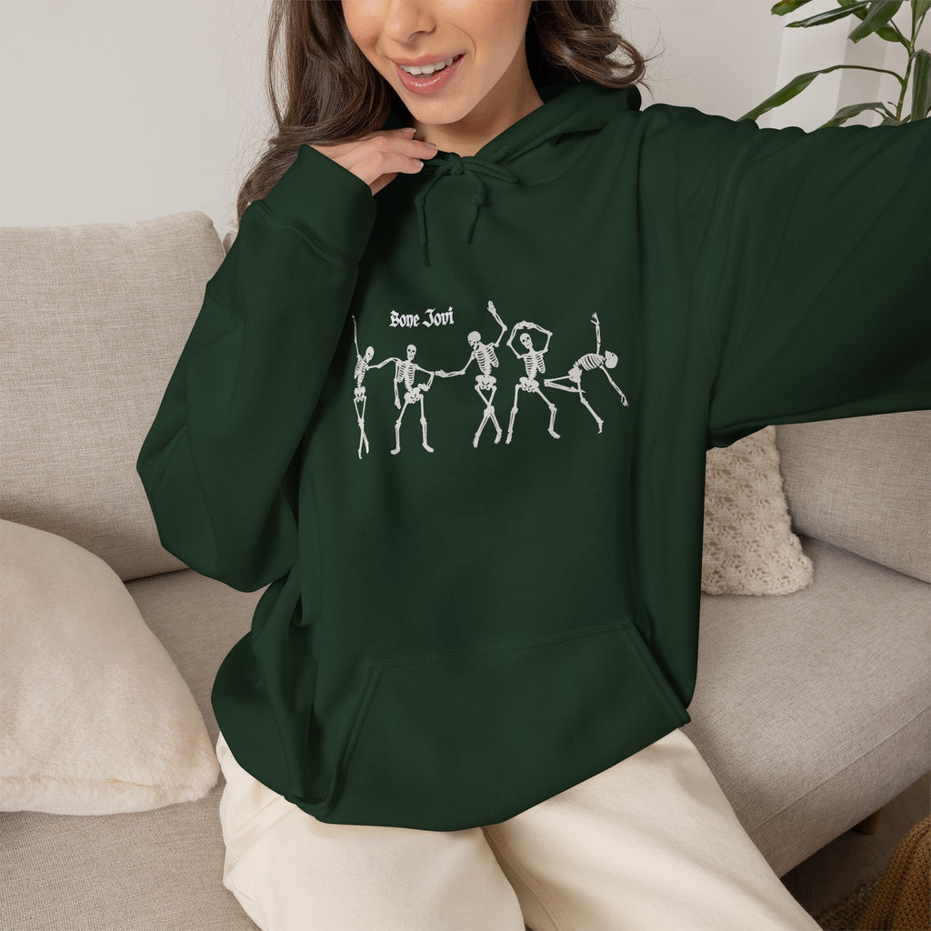 a women wearing a green  hoodie with 6 dancing white skeletons with the words Bone Jovi against a white background