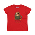 A red short-sleeve crewneck t-shirt featuring a cartoon owl sitting inside a green coffee mug with autumn leaves, and the text 'overstimulated under caffeinated doing my best' printed below. 
