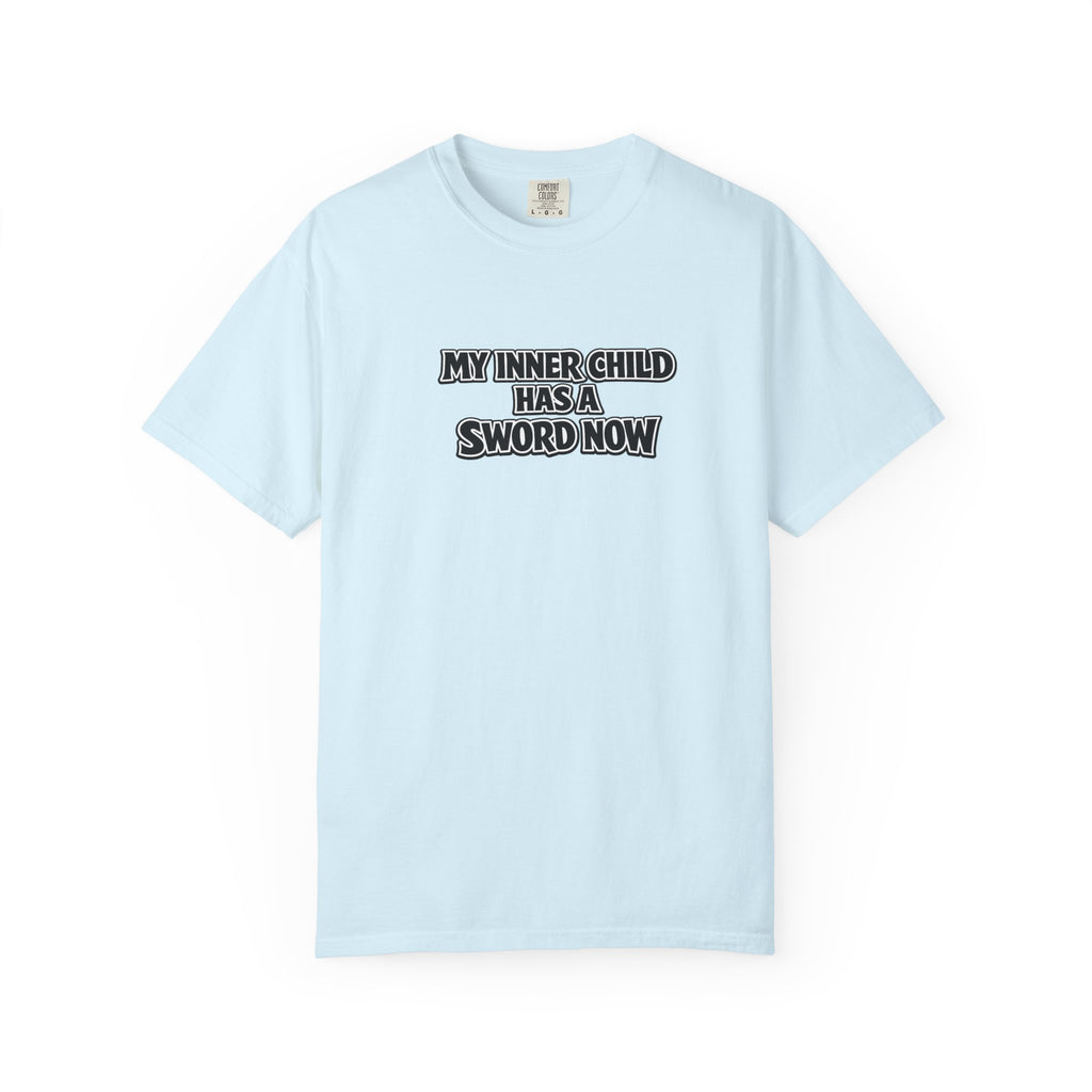 A light blue short-sleeve crewneck t-shirt with the text 'MY INNER CHILD HAS A SWORD NOW' printed in black and white block letters across the chest, displayed on a clean white background.