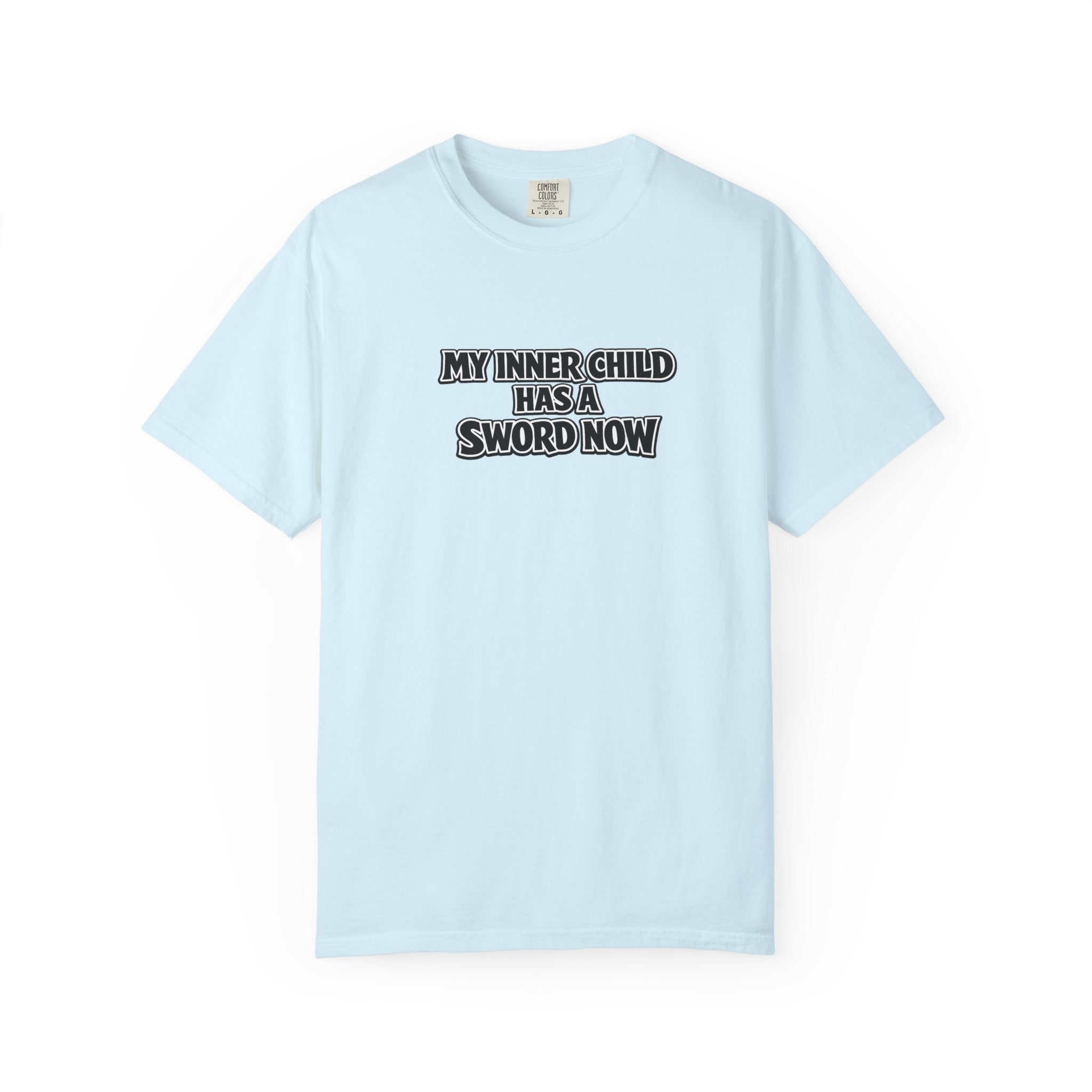 A light blue short-sleeve crewneck t-shirt with the text 'MY INNER CHILD HAS A SWORD NOW' printed in black and white block letters across the chest, displayed on a clean white background.