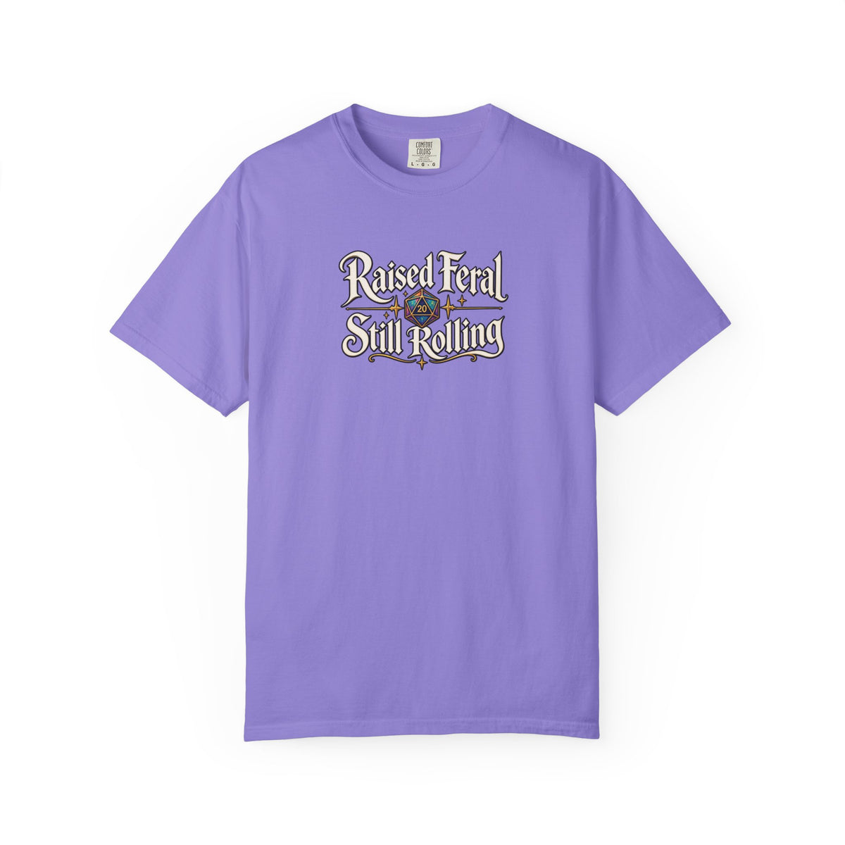 A purple graphic T-shirt  that features the text 'Raised Feral Still Rolling' with a colorful 20-sided die graphic in the center against a white background