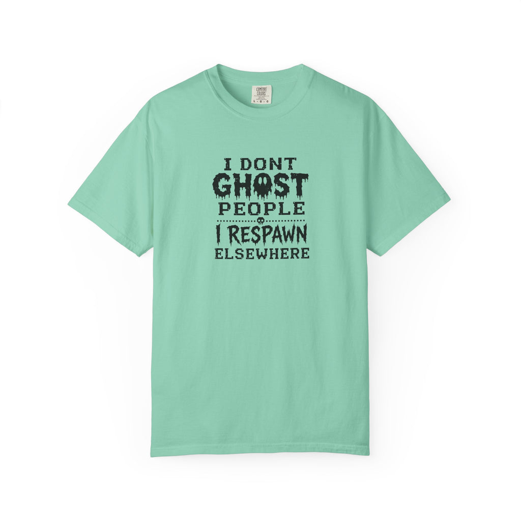 A mint green short-sleeve t-shirt with a black distressed text graphic on the chest that reads 'I DONT GHOST PEOPLE I RESPAWN ELSEWHERE'. The t-shirt is displayed flat against a clean white background.