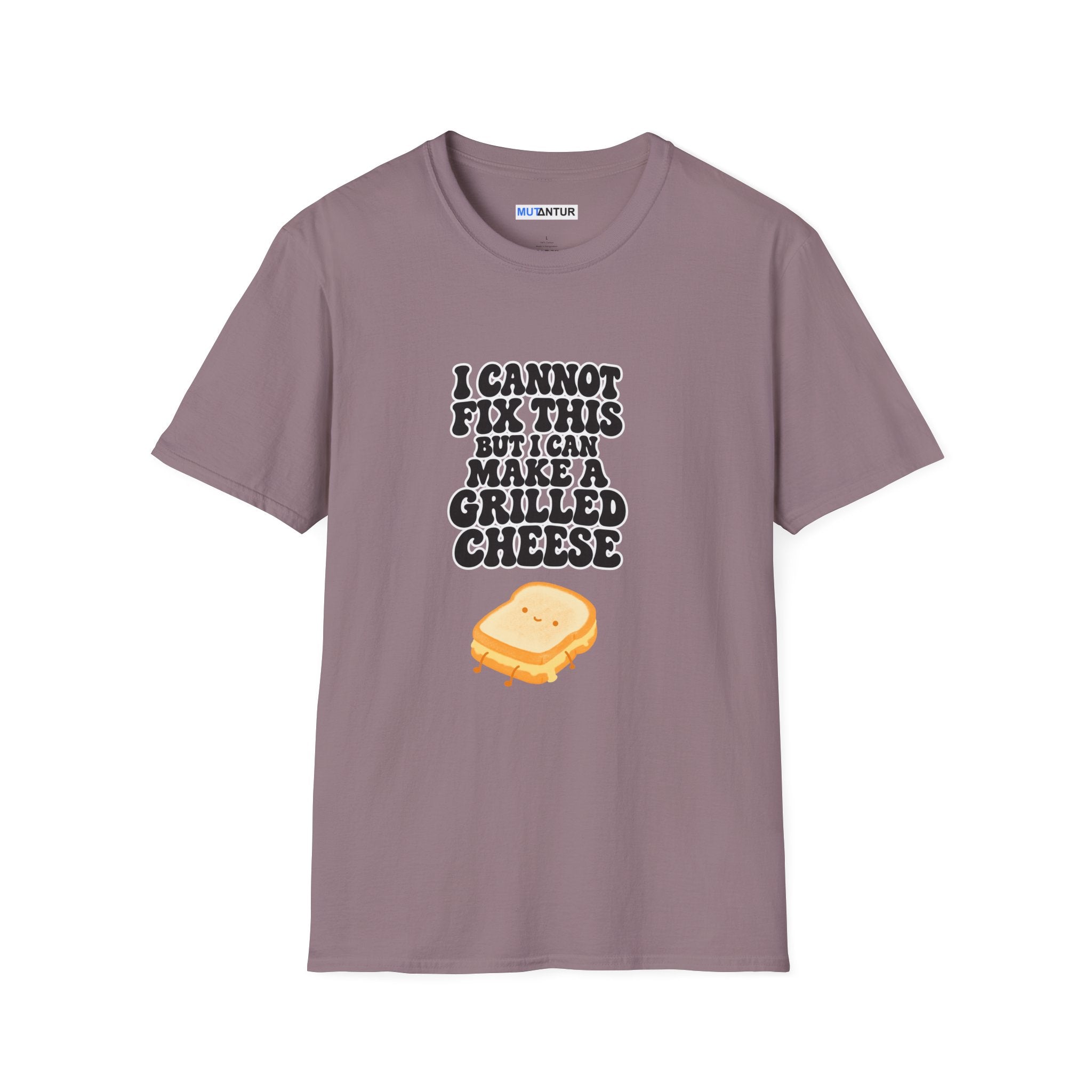 A mauve-colored short-sleeve t-shirt with a graphic print on the front. The graphic features the text 'I CANNOT FIX THIS BUT I CAN MAKE A GRILLED CHEESE' in black and white bubble letters above a cartoon illustration of a grilled cheese sandwich.