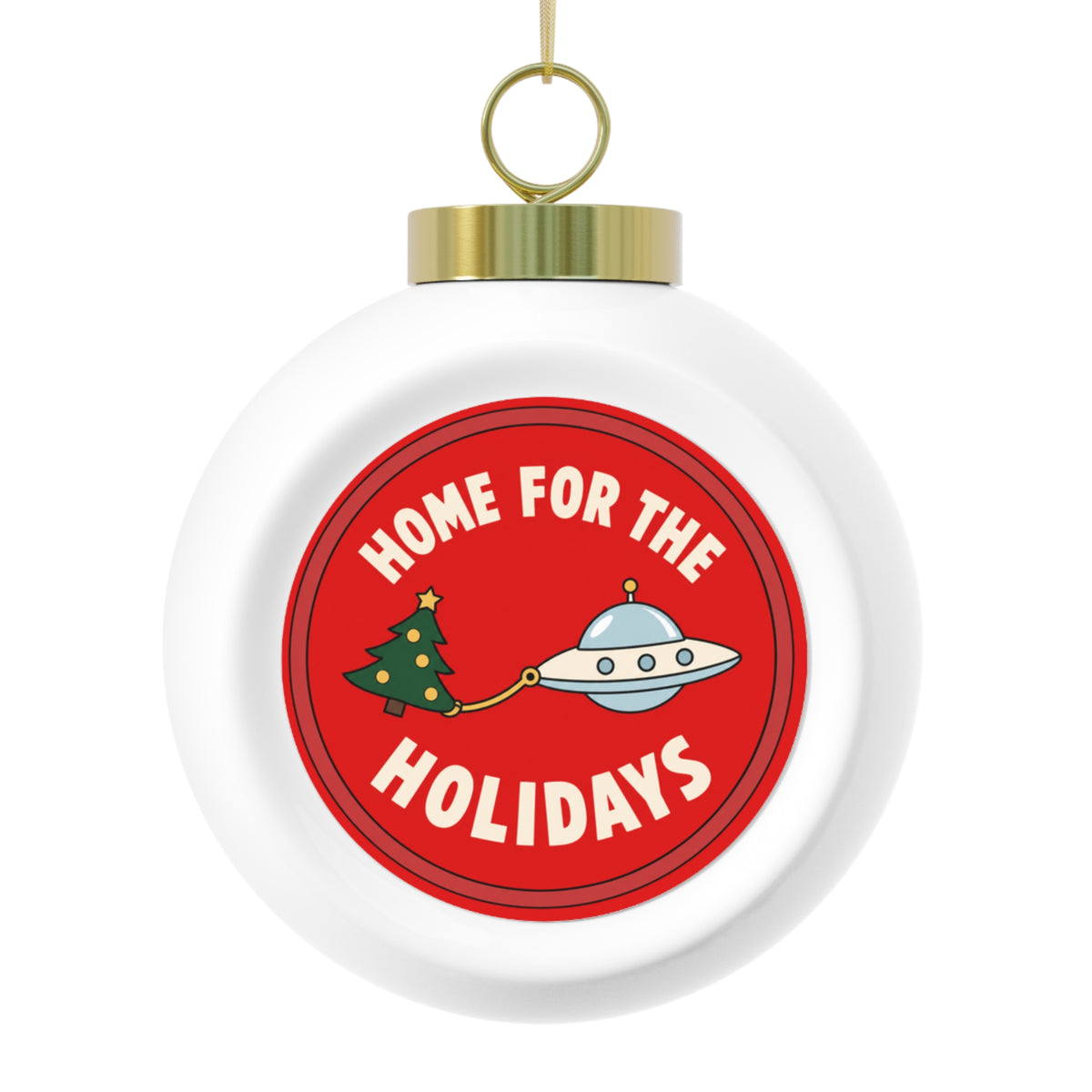 A round white Christmas ornament with a gold hanging loop and cap, featuring a red circular graphic that reads 'HOME FOR THE HOLIDAYS' with a small tree and flying saucer illustration.