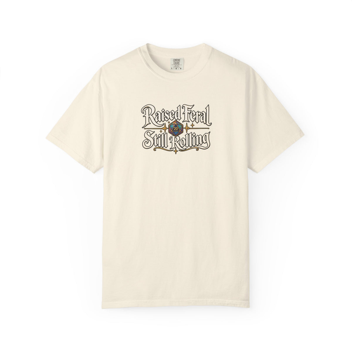 A beige graphic T-shirt  that features the text 'Raised Feral Still Rolling' with a colorful 20-sided die graphic in the center against a white background