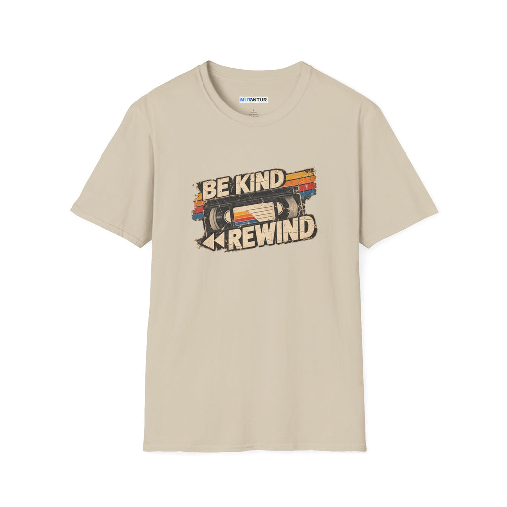 A beige crewneck t-shirt with a retro graphic on the chest featuring a VHS tape and the words 'BE KIND' and 'REWIND' in a distressed font. The brand name 'MUTANTUR' is visible on the inner neck label.