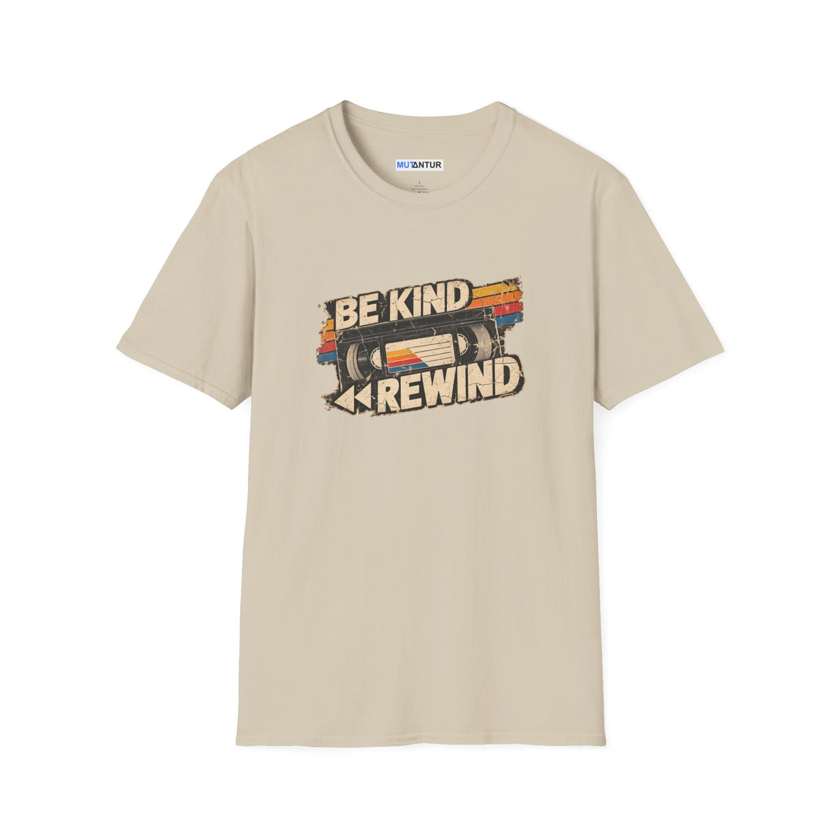 A beige crewneck t-shirt with a retro graphic on the chest featuring a VHS tape and the words 'BE KIND' and 'REWIND' in a distressed font. The brand name 'MUTANTUR' is visible on the inner neck label.