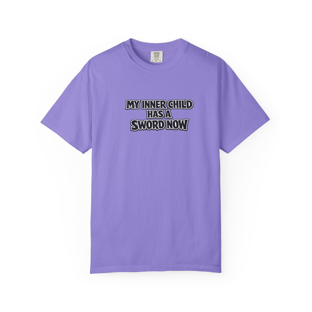 A light purple short-sleeve t-shirt with the text 'MY INNER CHILD HAS A SWORD NOW' printed in black and white block letters on the chest, displayed on a clean white background.