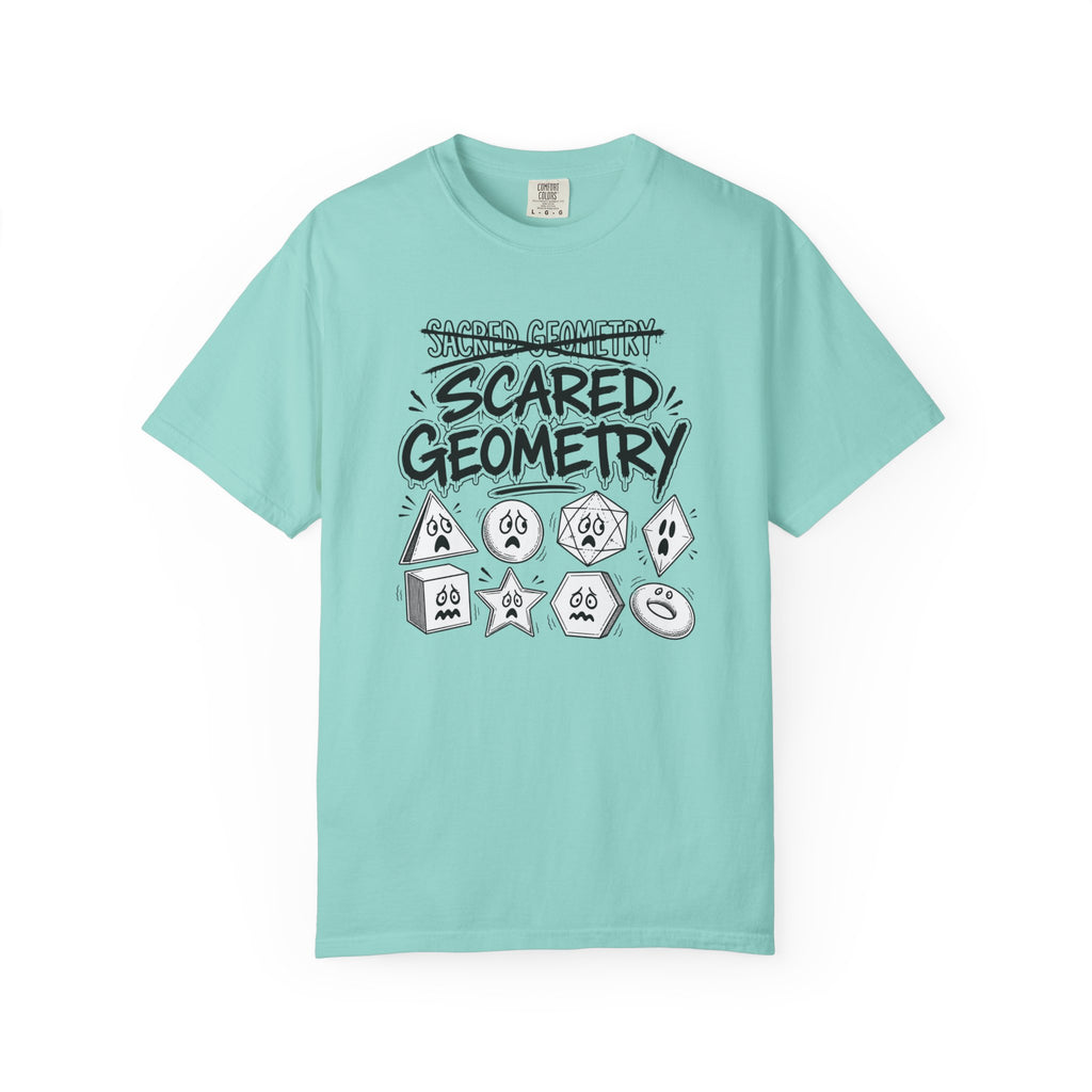 A light mint green t-shirt with a graphic print on the front that reads 'SCARED GEOMETRY' in black hand-drawn text above various cartoonish geometric shapes in white and black, displayed on a clean white background.