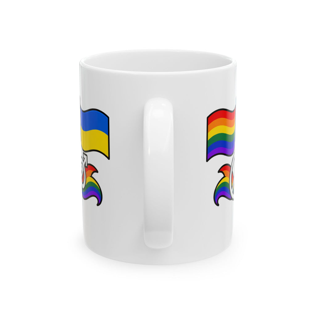 A white ceramic coffee mug featuring a graphic design of a Ukrainian flag on the left and a rainbow pride flag on the right, with a rainbow-colored eagle emblem below each flag.