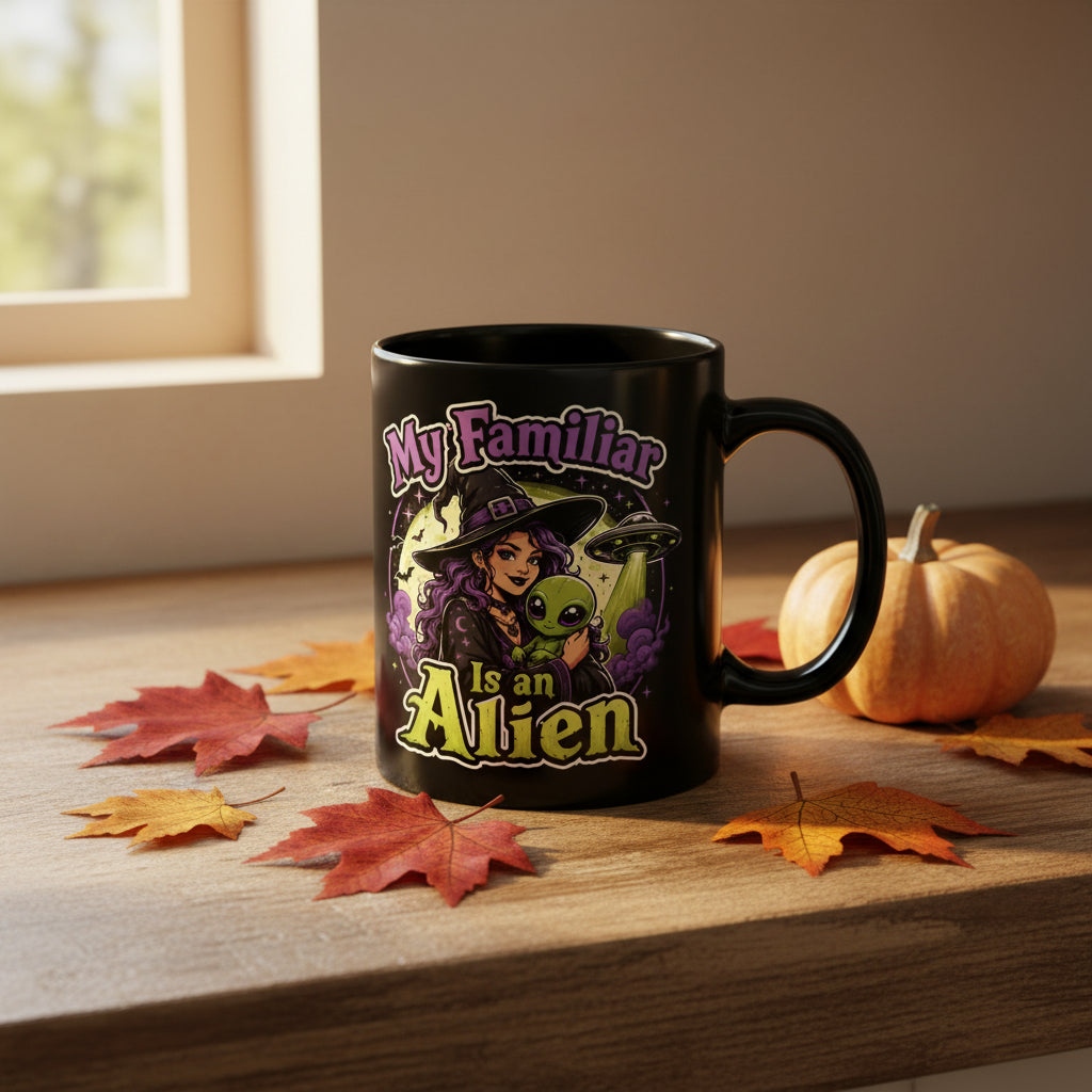 Black mug with a colorful graphic depicting a witch holding a green alien with the words: My familiar is an alien