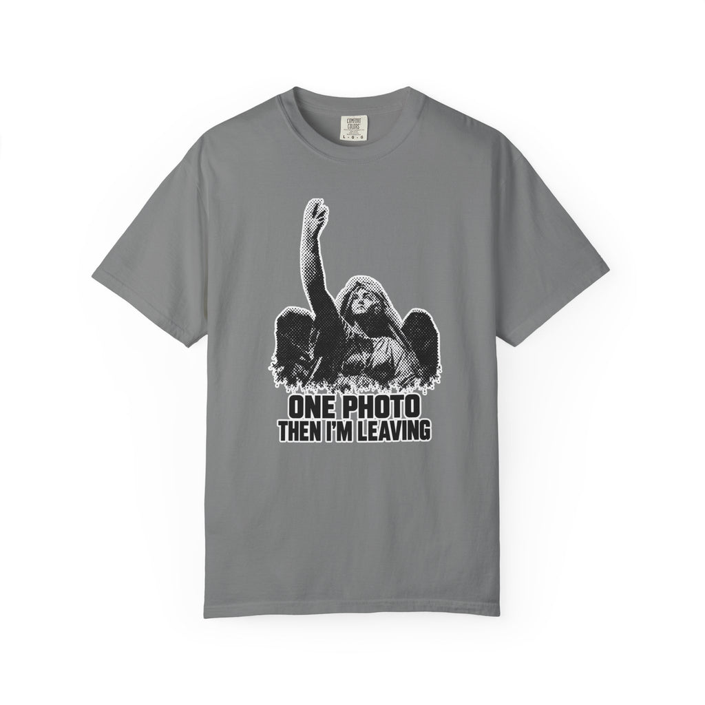 A gray short-sleeve crewneck t-shirt featuring a black and white graphic of a winged angel with raised hand and the text 'ONE PHOTO THEN I'M LEAVING' printed on the front.