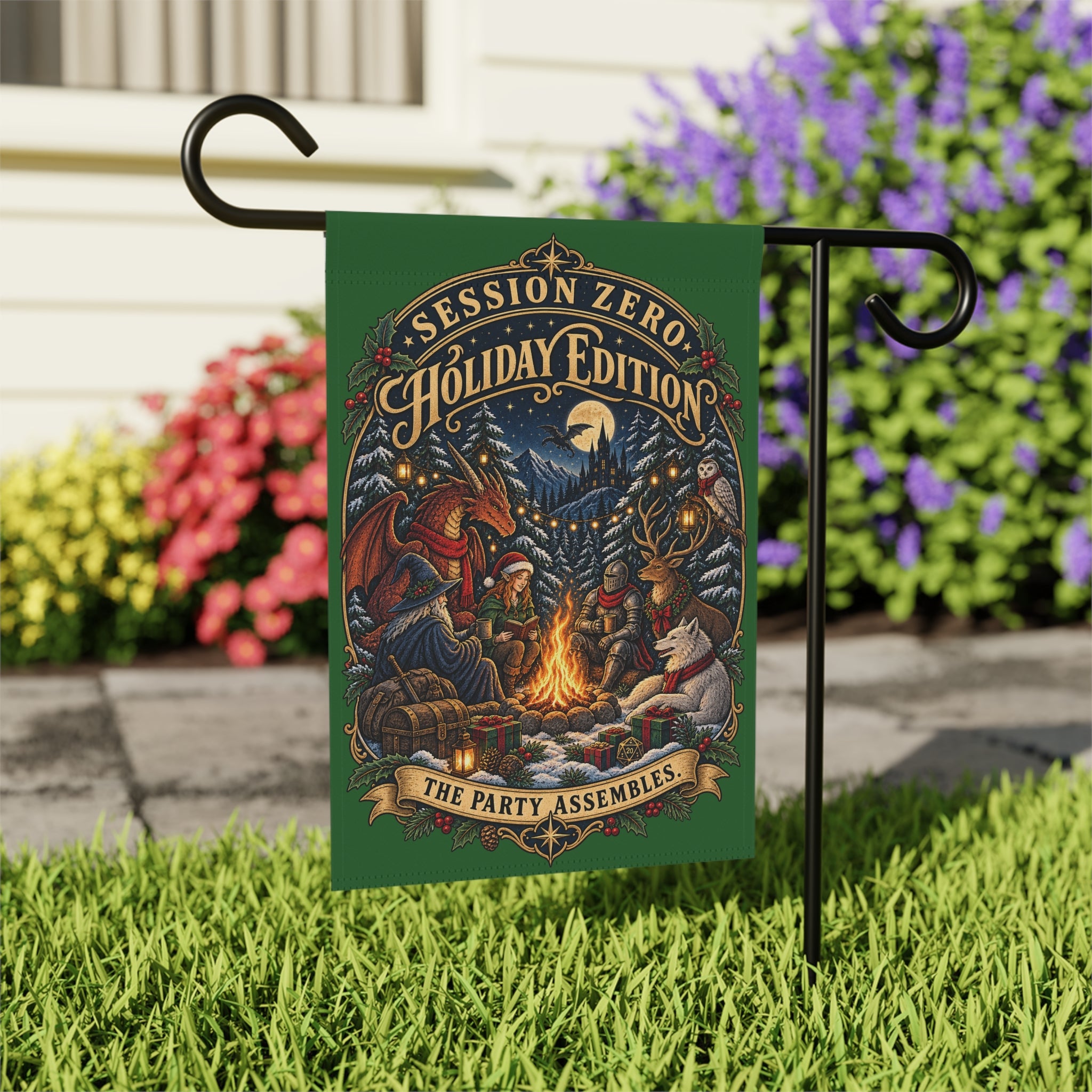 A decorative garden flag on a black metal stand in a grassy yard. The flag has a dark green background with an illustrated holiday campfire scene and the text 'SESSION ZERO HOLIDAY EDITION' and 'THE PARTY ASSEMBLES'.
