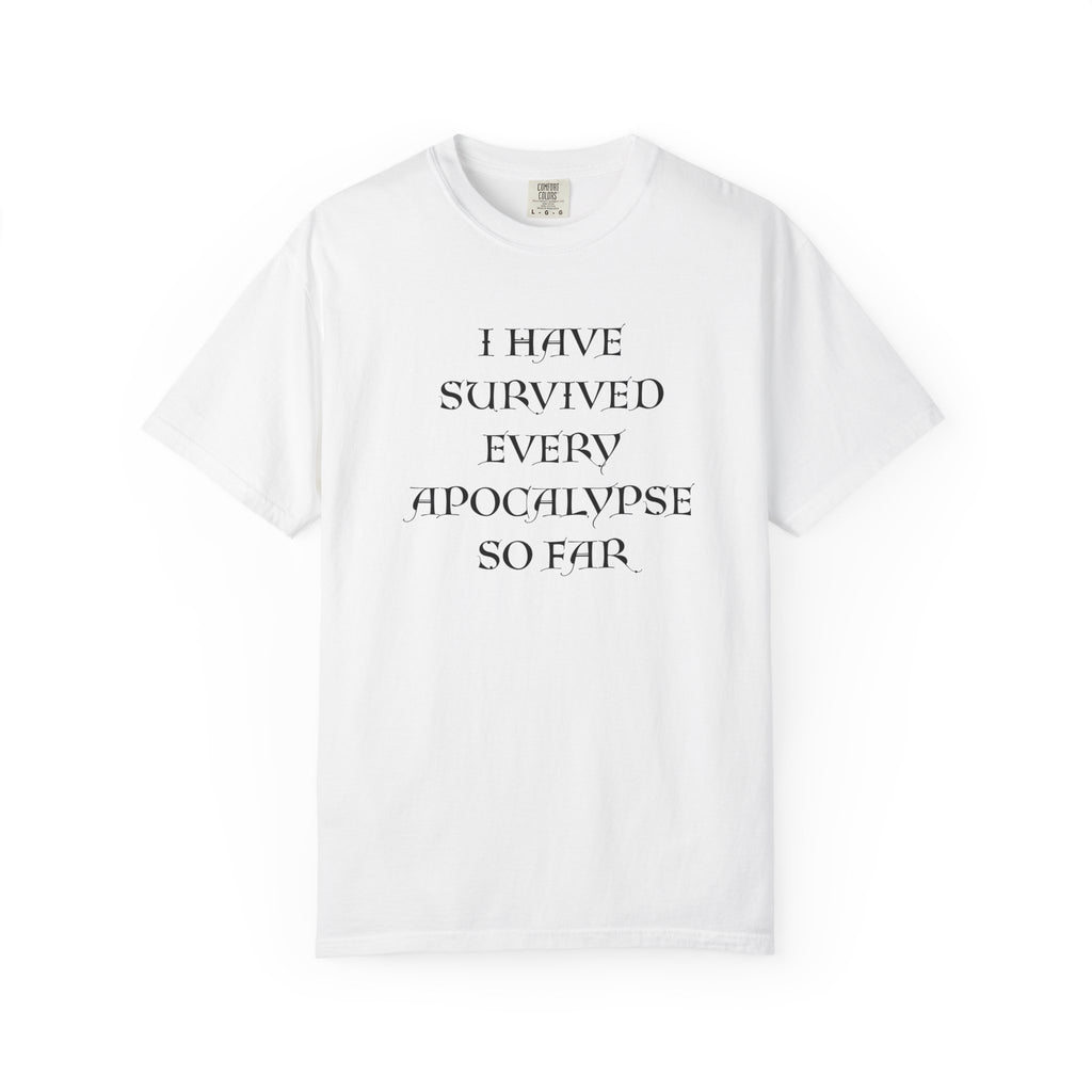 A white short-sleeve crewneck t-shirt with black text on the front reading 'I HAVE SURVIVED EVERY APOCALYPSE SO FAR.' displayed on a clean white background.