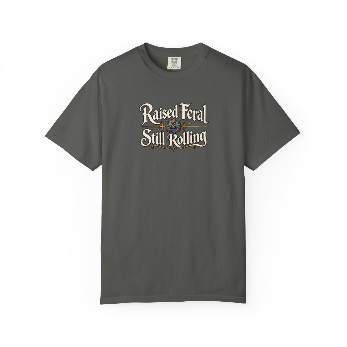 A gray graphic T-shirt  that features the text 'Raised Feral Still Rolling' with a colorful 20-sided die graphic in the center against a white background